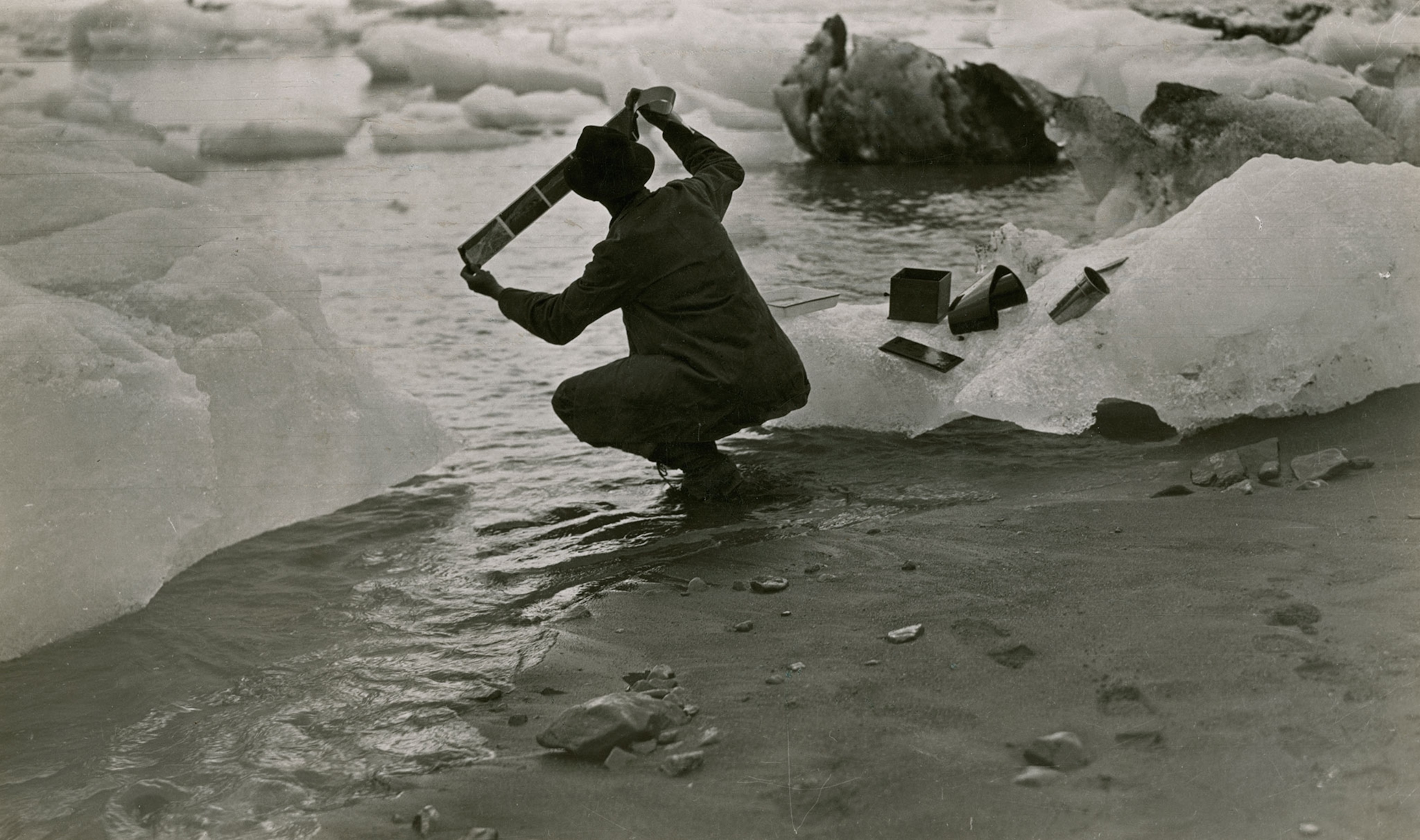 a man processing film next to an iceberg.