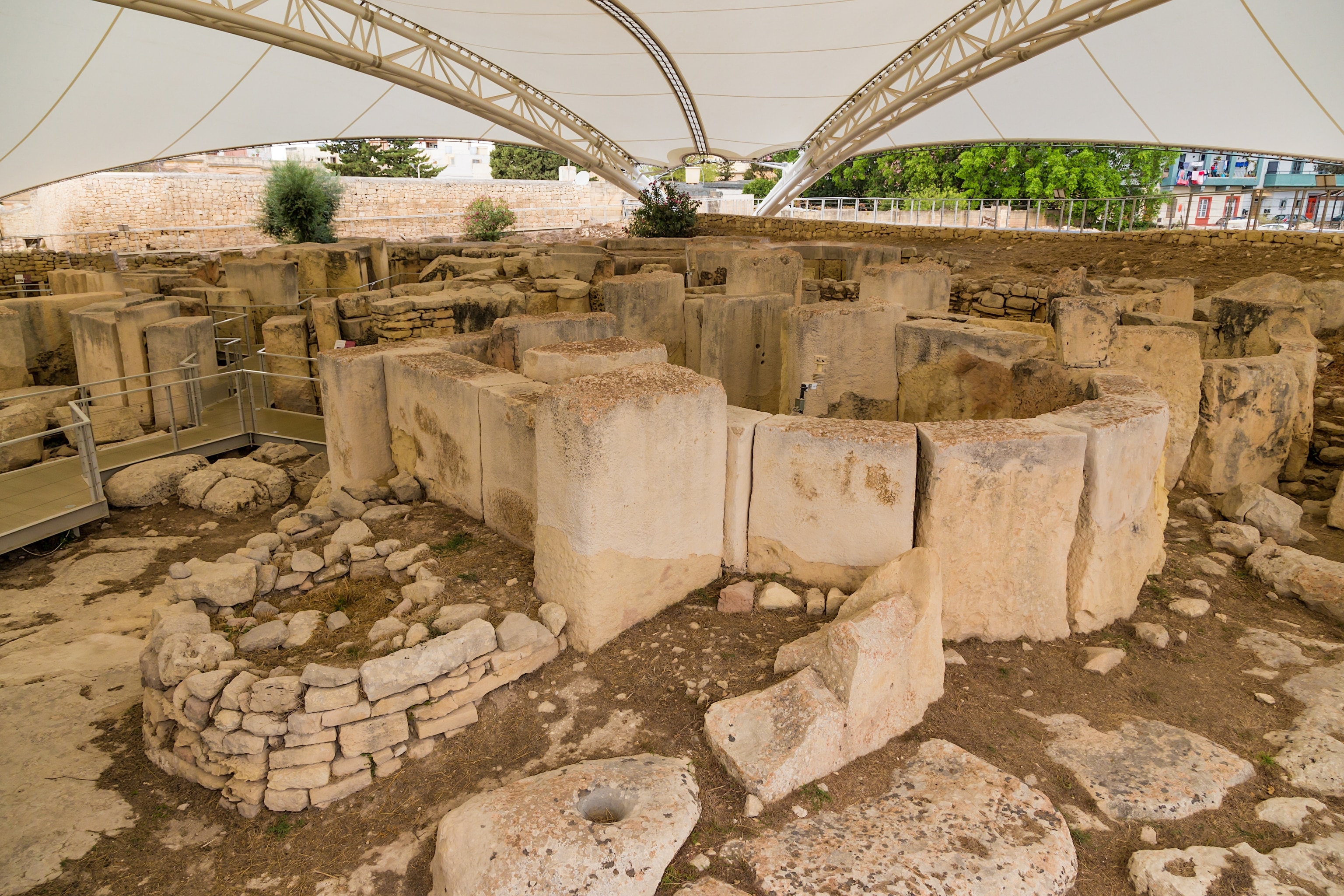 Stone structures under a tarp.