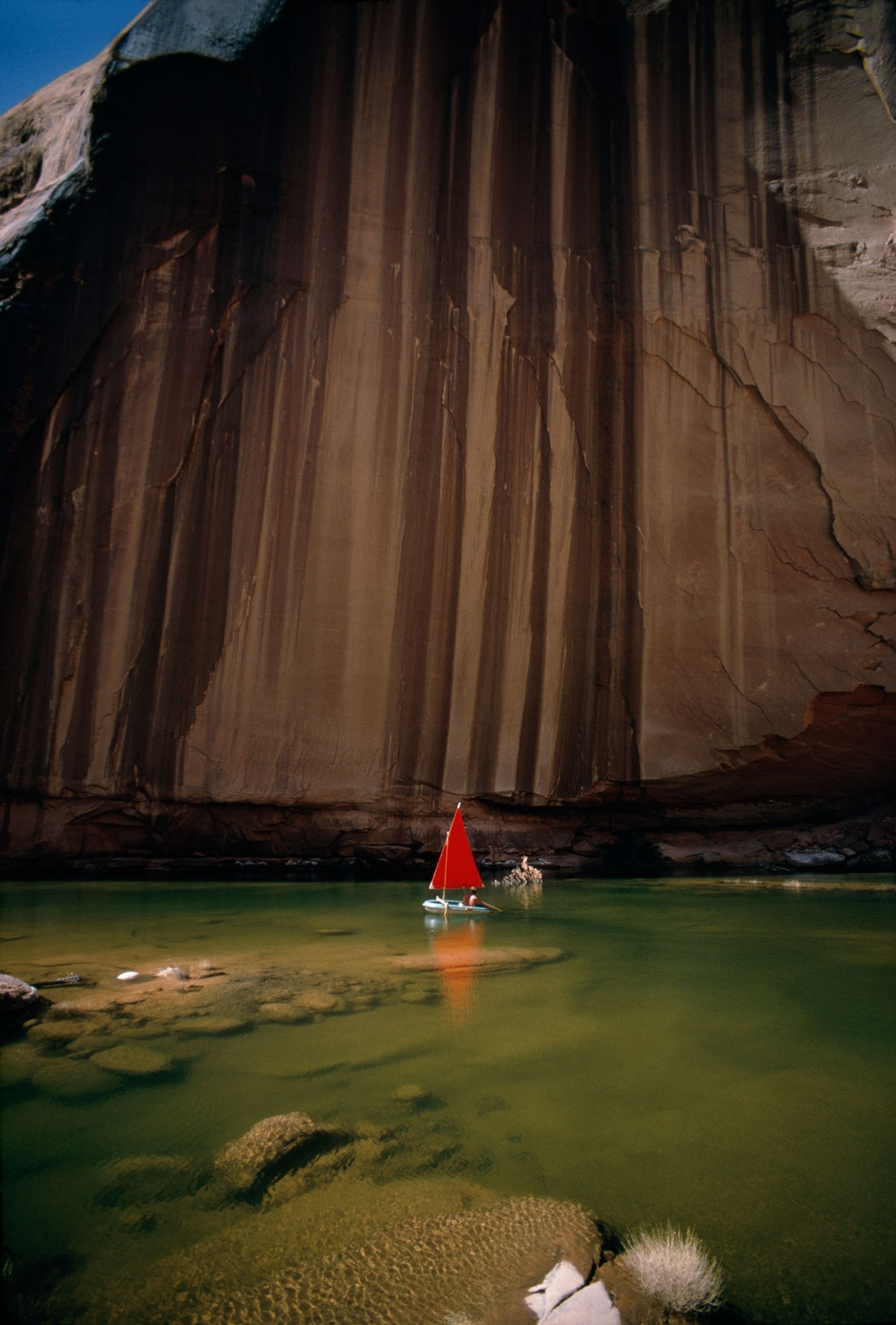 red sailboat in landscape