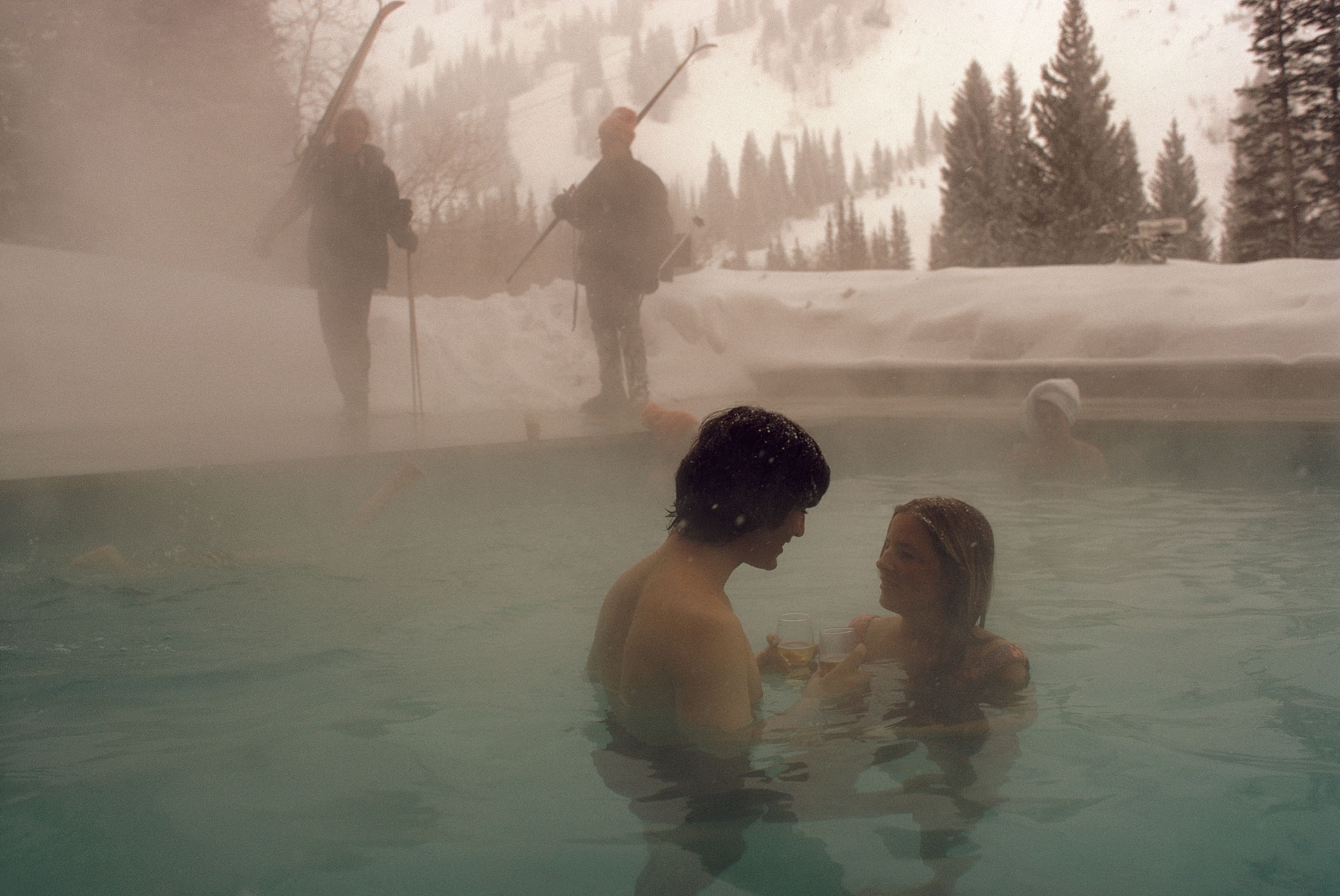 a couple relaxing in a heated pool