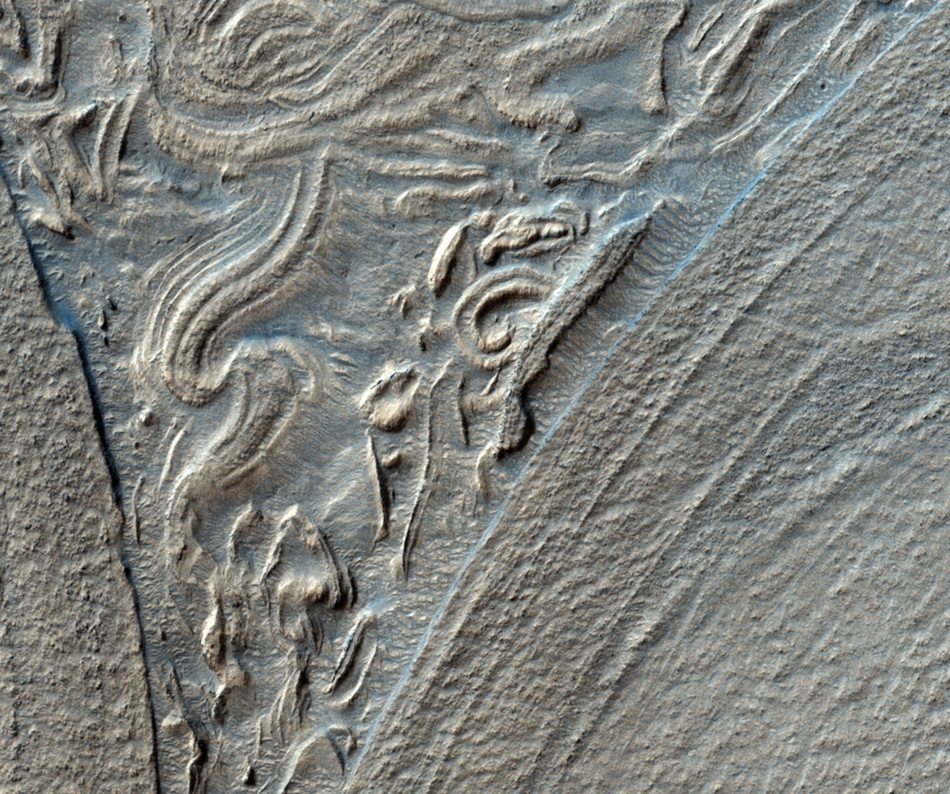 swirling landforms in a Martian basin