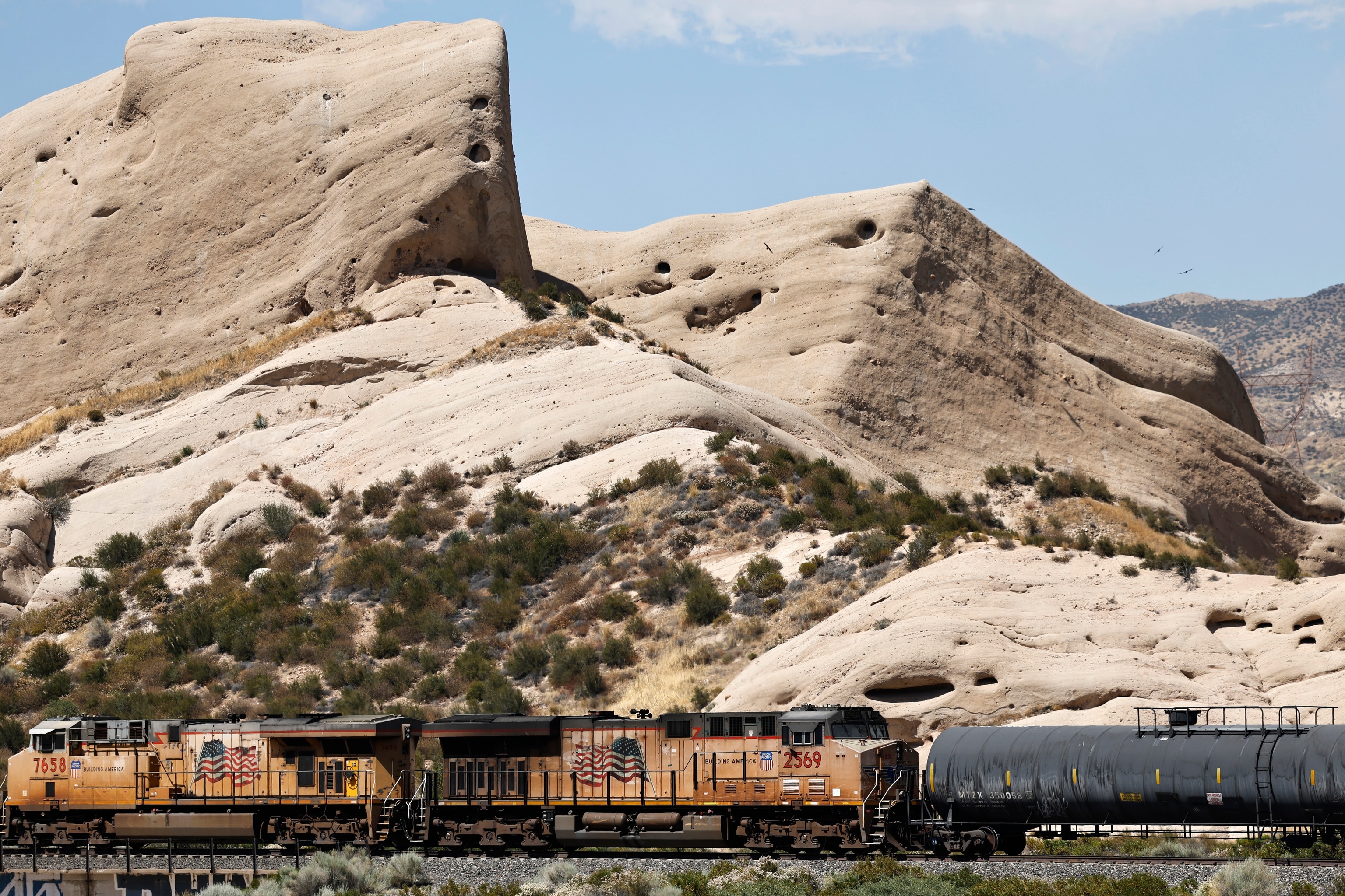 A freight train passes the Mormon Rocks along the Cajon Pass near the San Andreas fault.