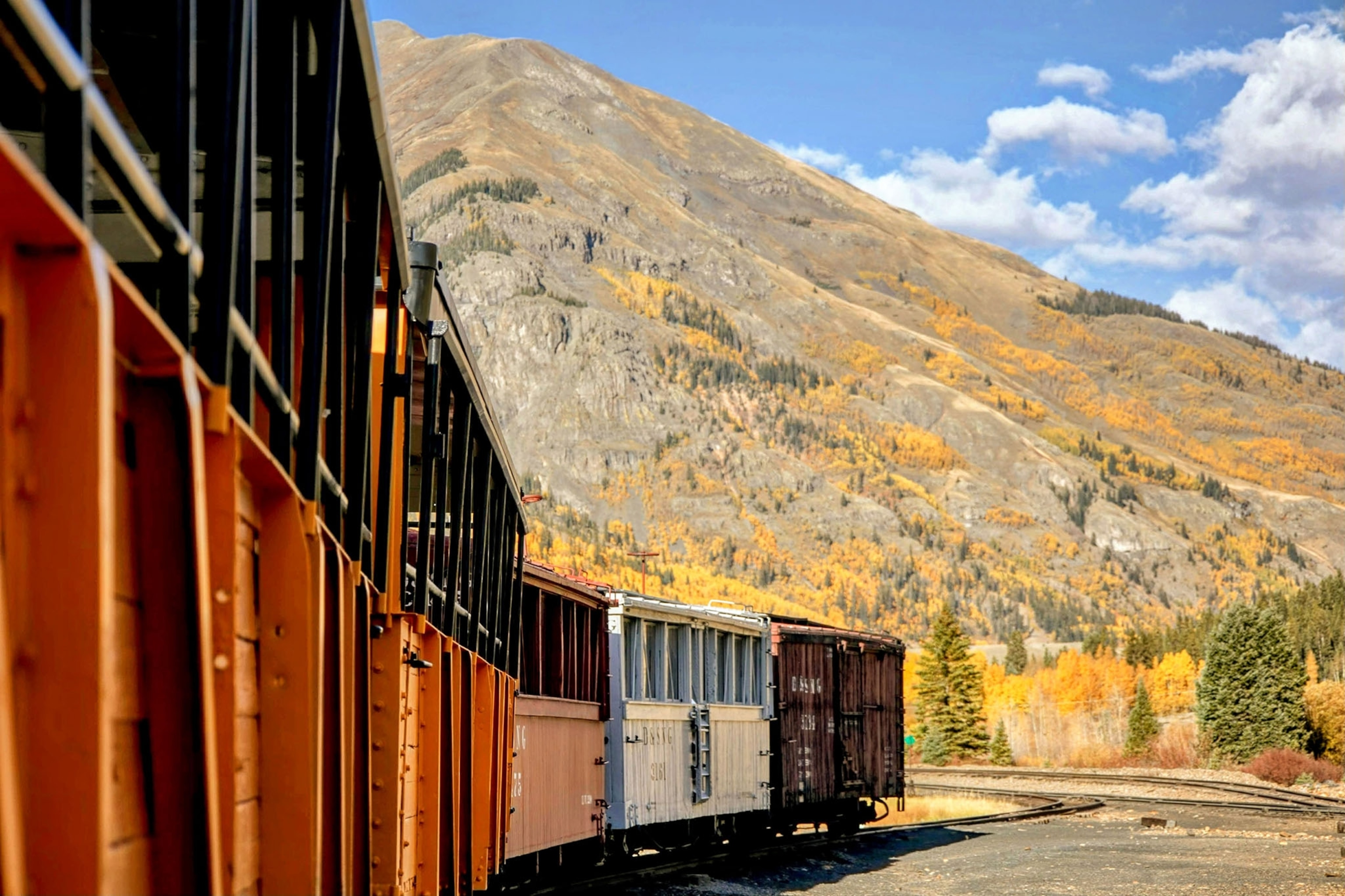 A POV shot taken from on board a train as it goes around a curve in the mountains.