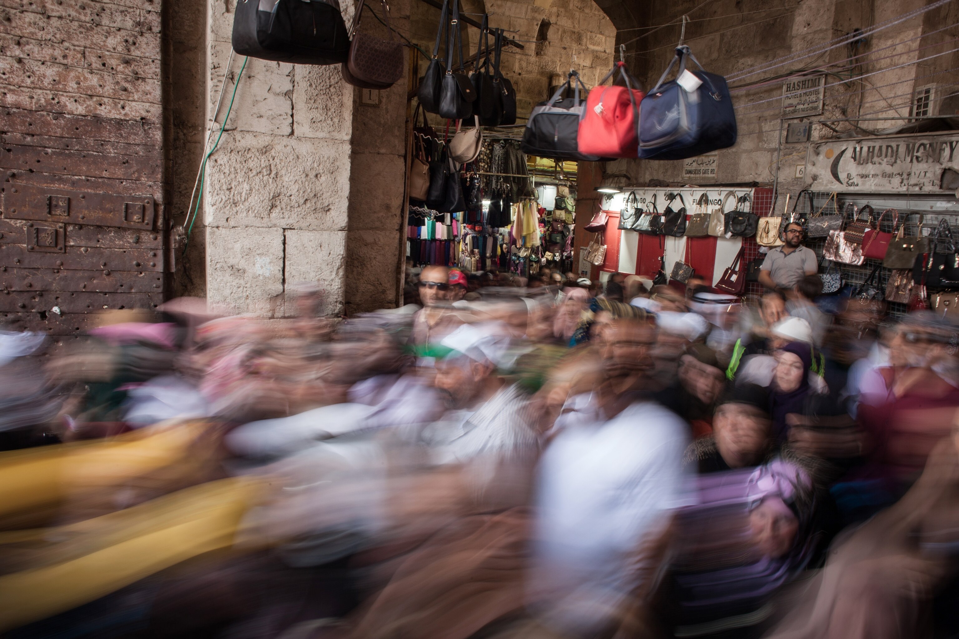 a crowd exiting the old city of Jerusalem through Damascus gate in Jerusalem, Israel