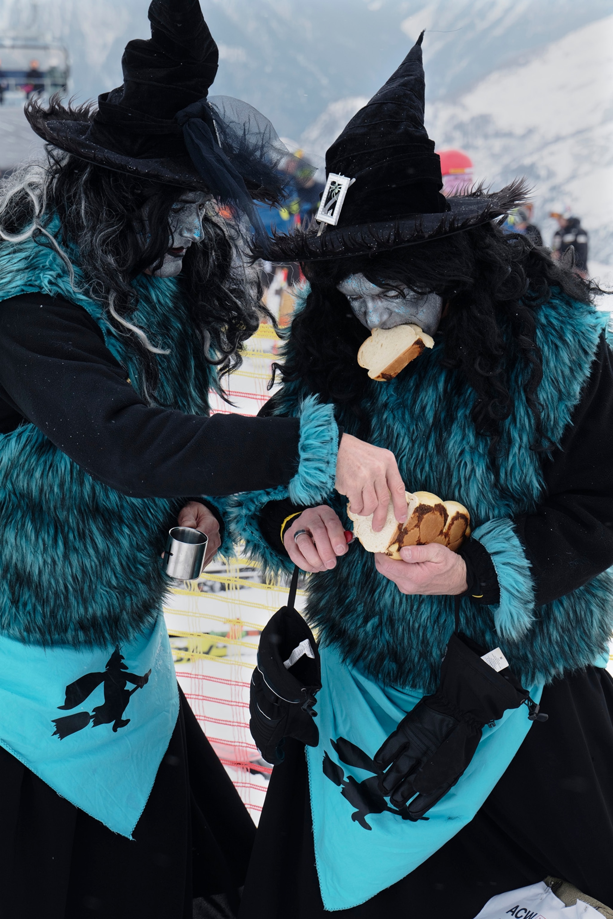 Two skiers dressed as witches cut bread during Belalp Hexen festival in Belalp, Switzerland. For participants in the main event, people dressed as witches ski down a race course, stopping along the way to picnic and drink alcohol.