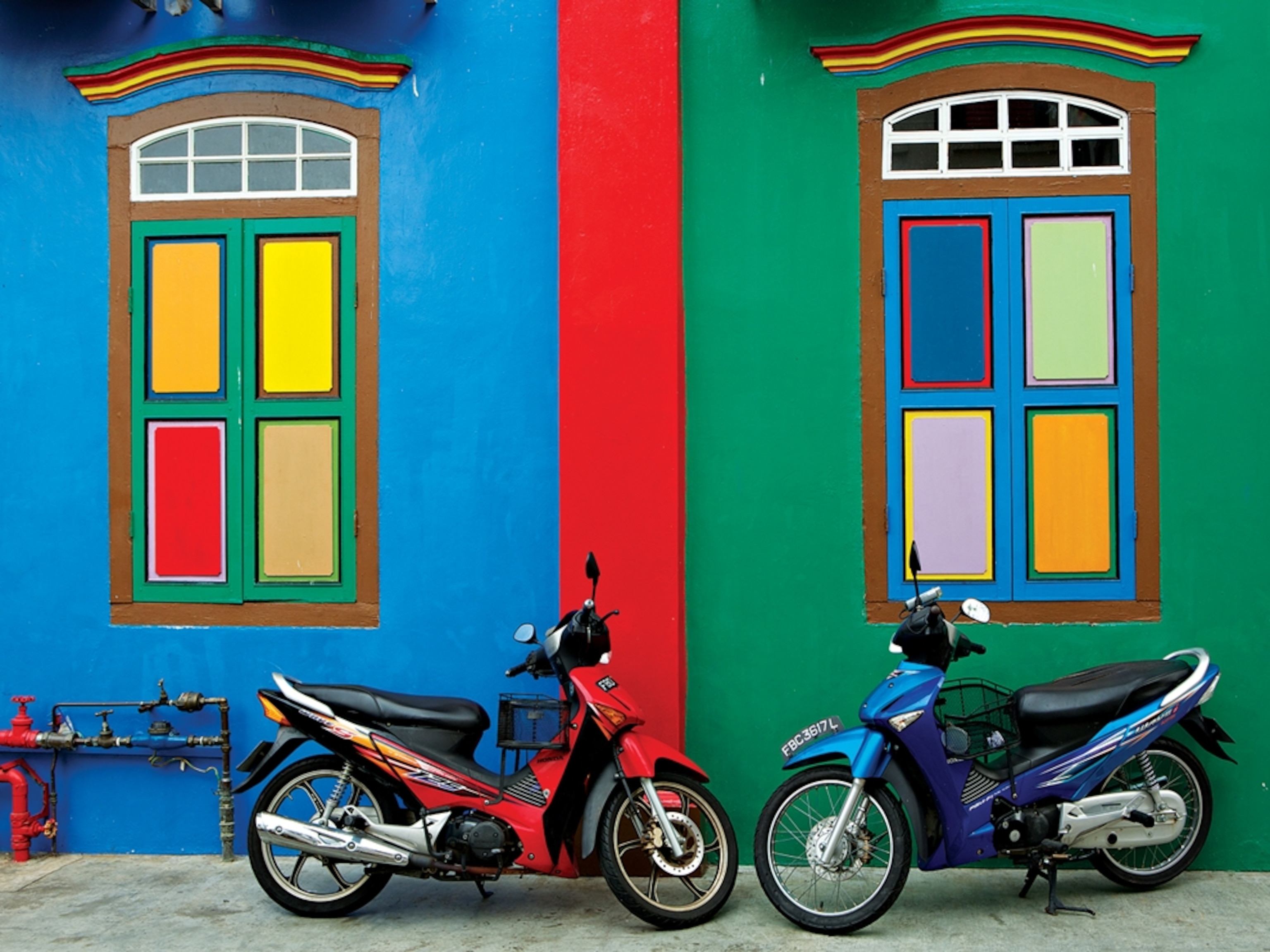 motorcycles by colorful wall