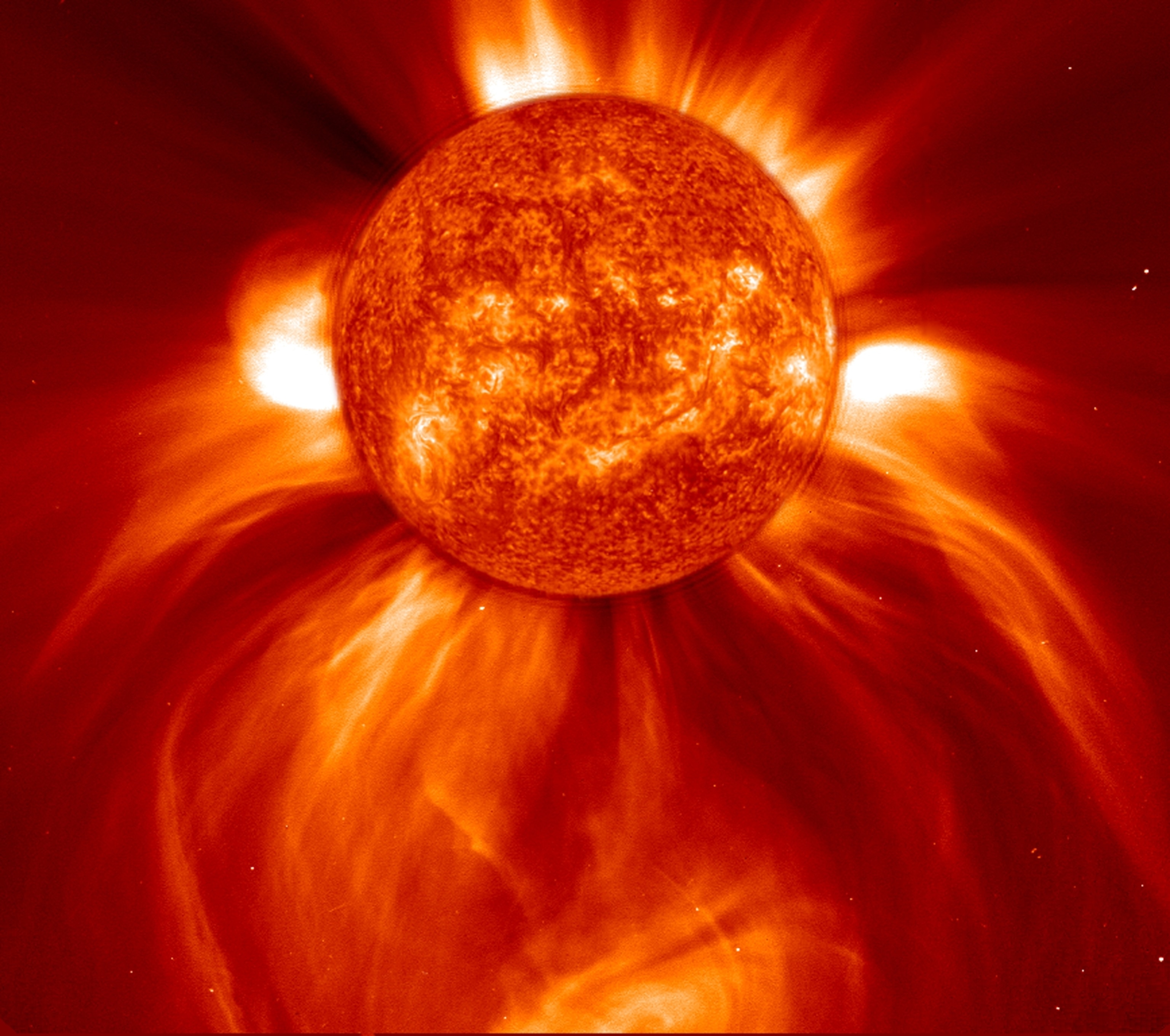 Fiery solar flare erupts from the sun in a vibrant red-hued image. Bright, intense plumes of energy radiate outward