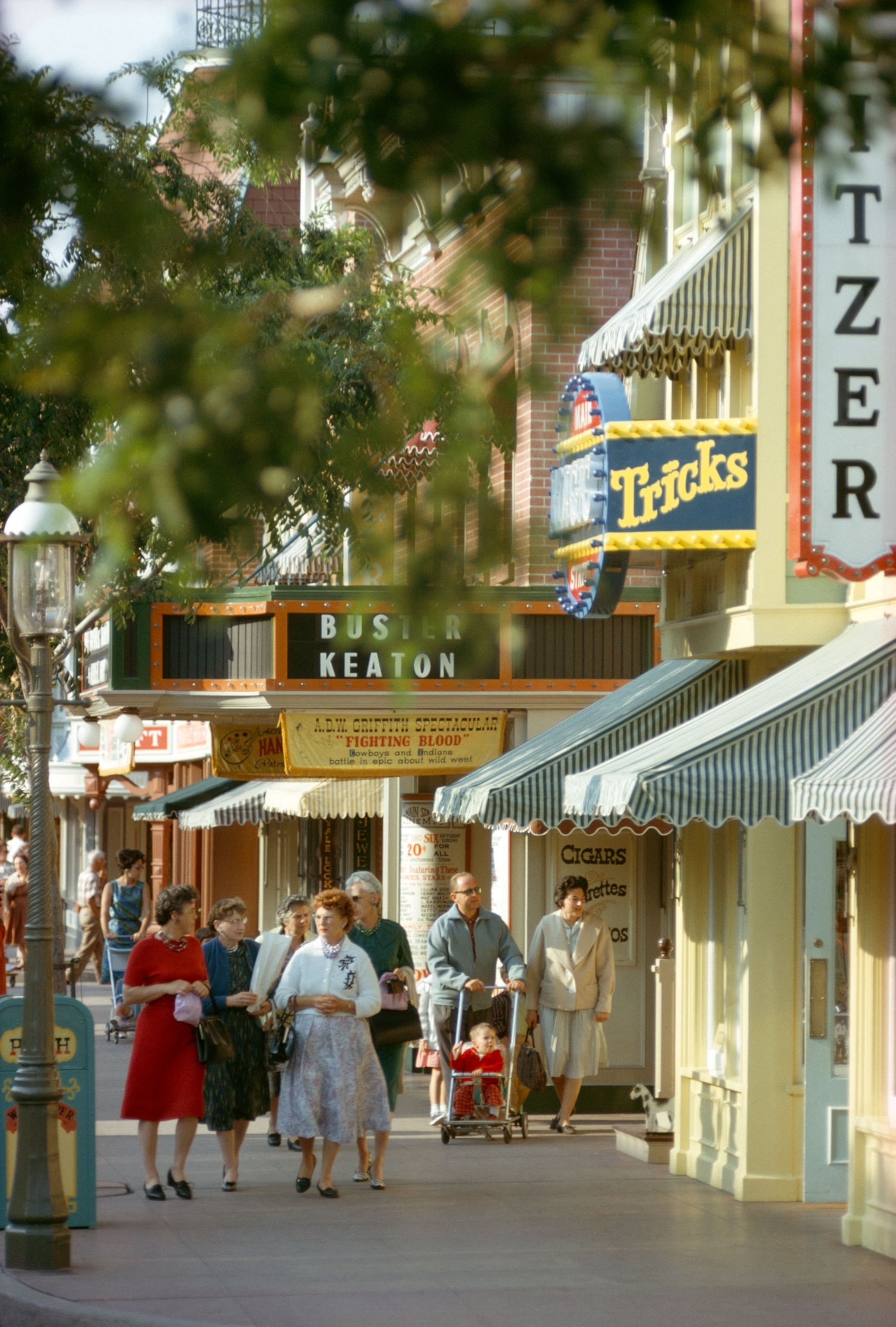 Tourists stroll a recreated American main street at Disneyland