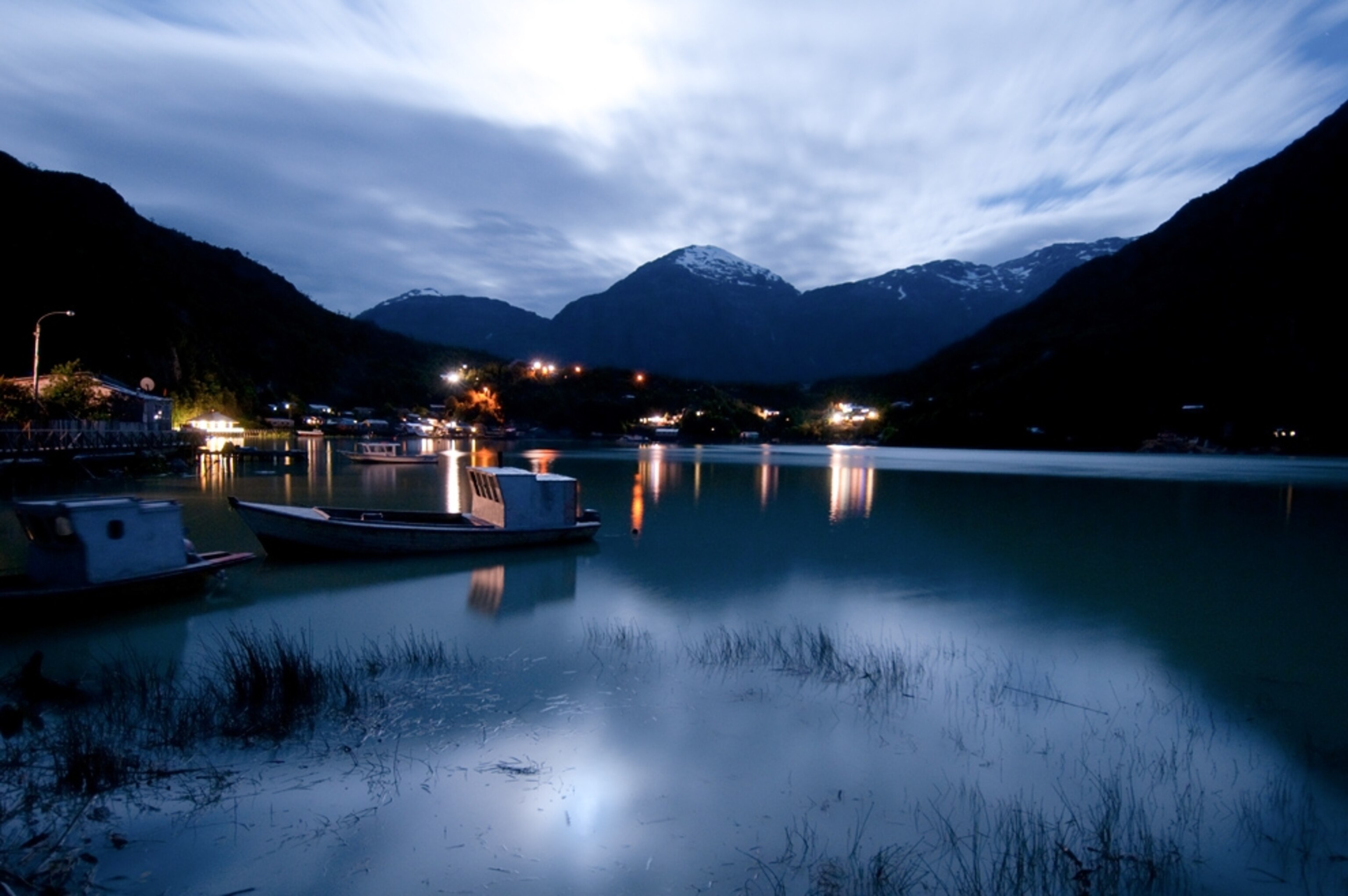 The lights of Tortel shine out across the waters of the Baker River