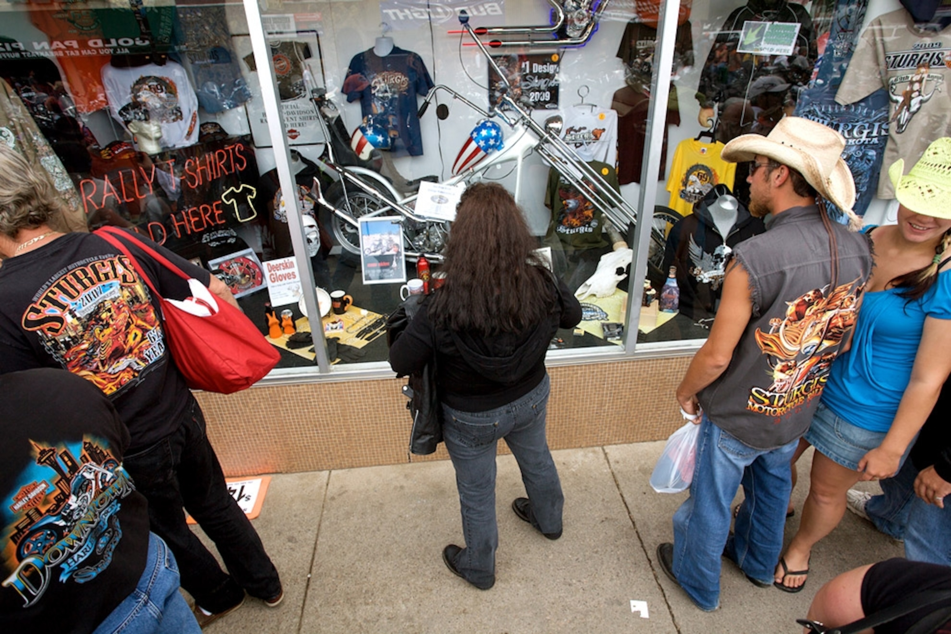 Bikers looking at souvenir shop window