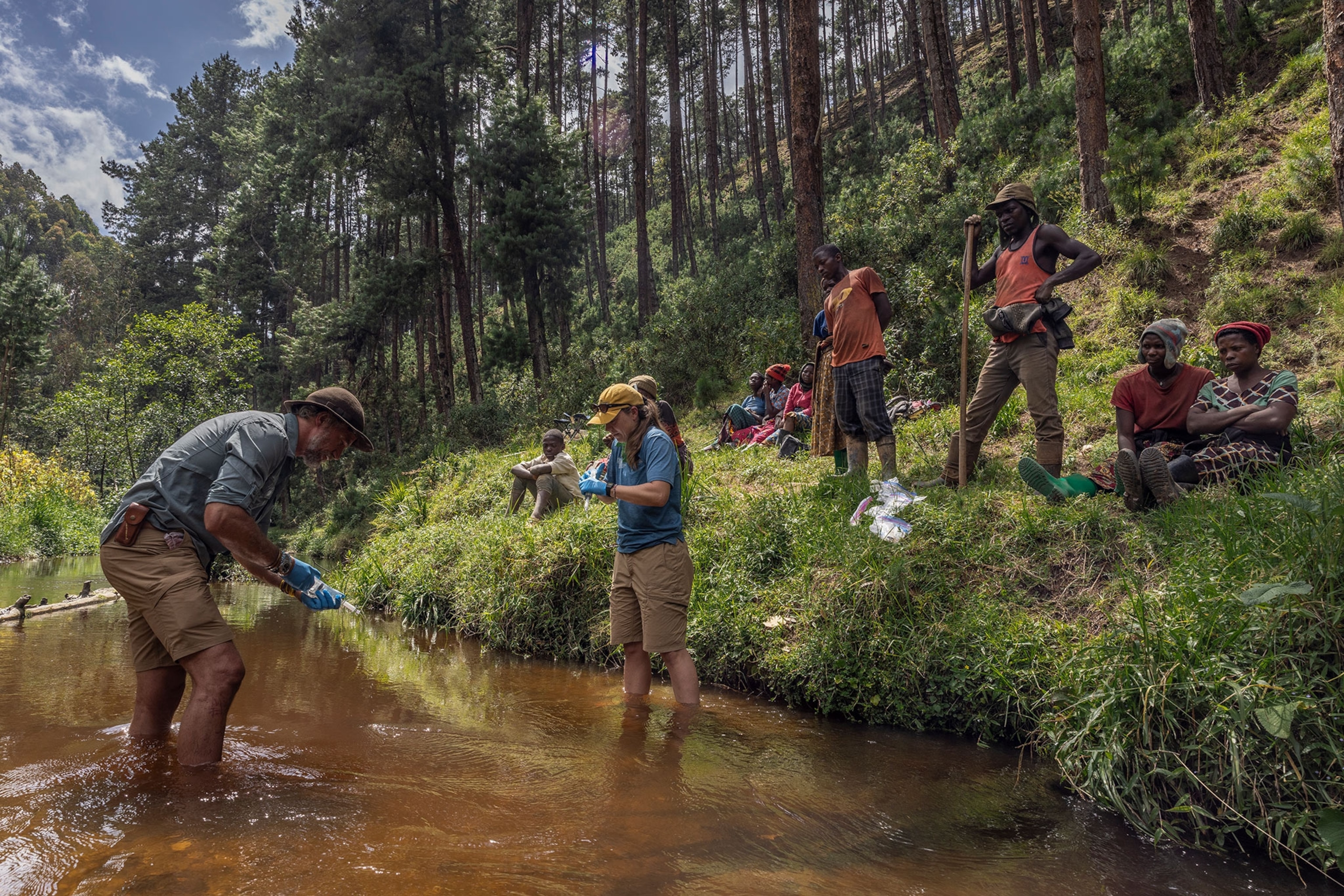 research team taking samples in a river