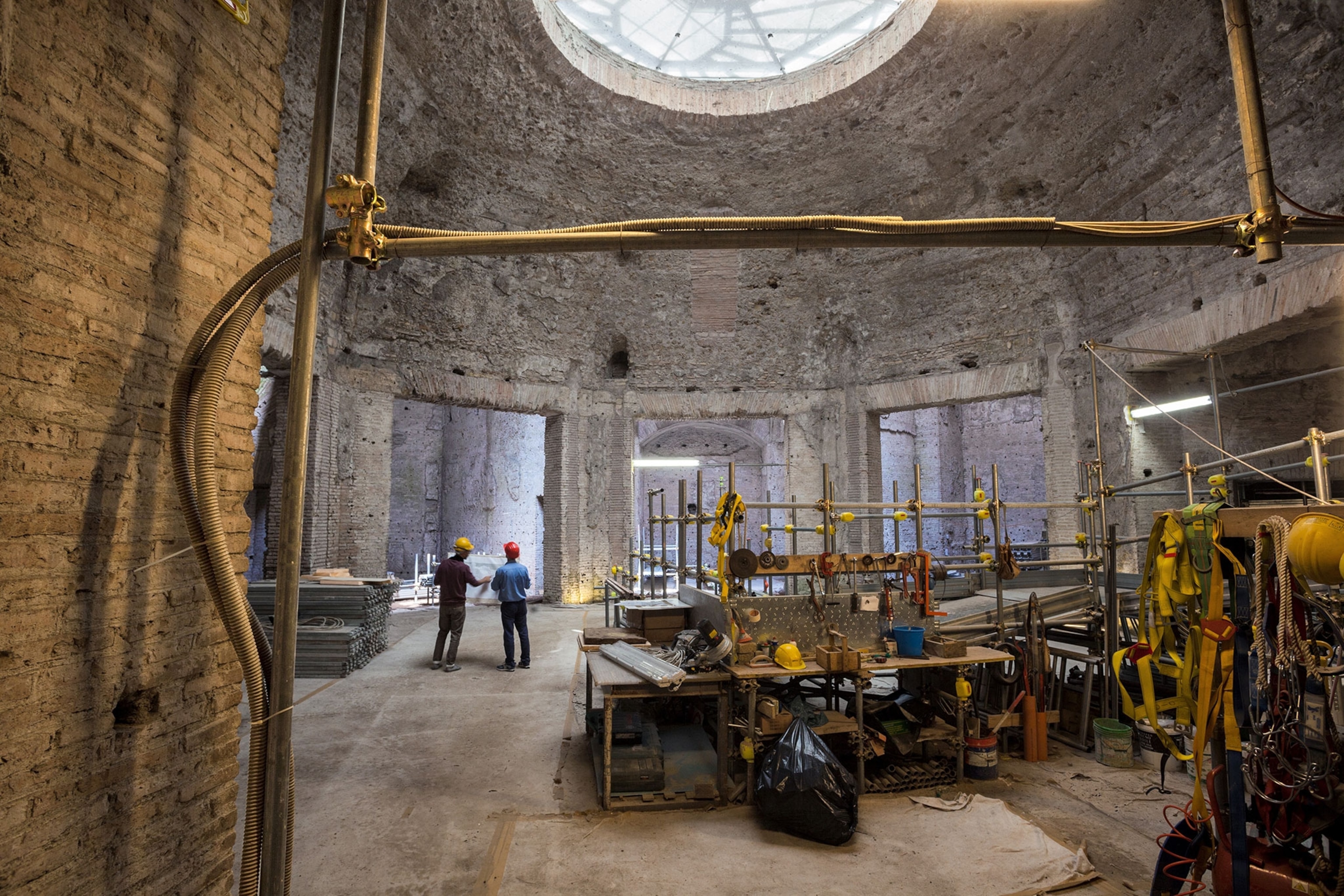 Workers restore the Octagonal Room in Nero's Domus Aurea palace, where the emperor likely hosted dinners. All surfaces would have been lavishly decorated. Pieces of blue, green, and white glass found in excavation may have lined the domeas twinkling mosaics.
