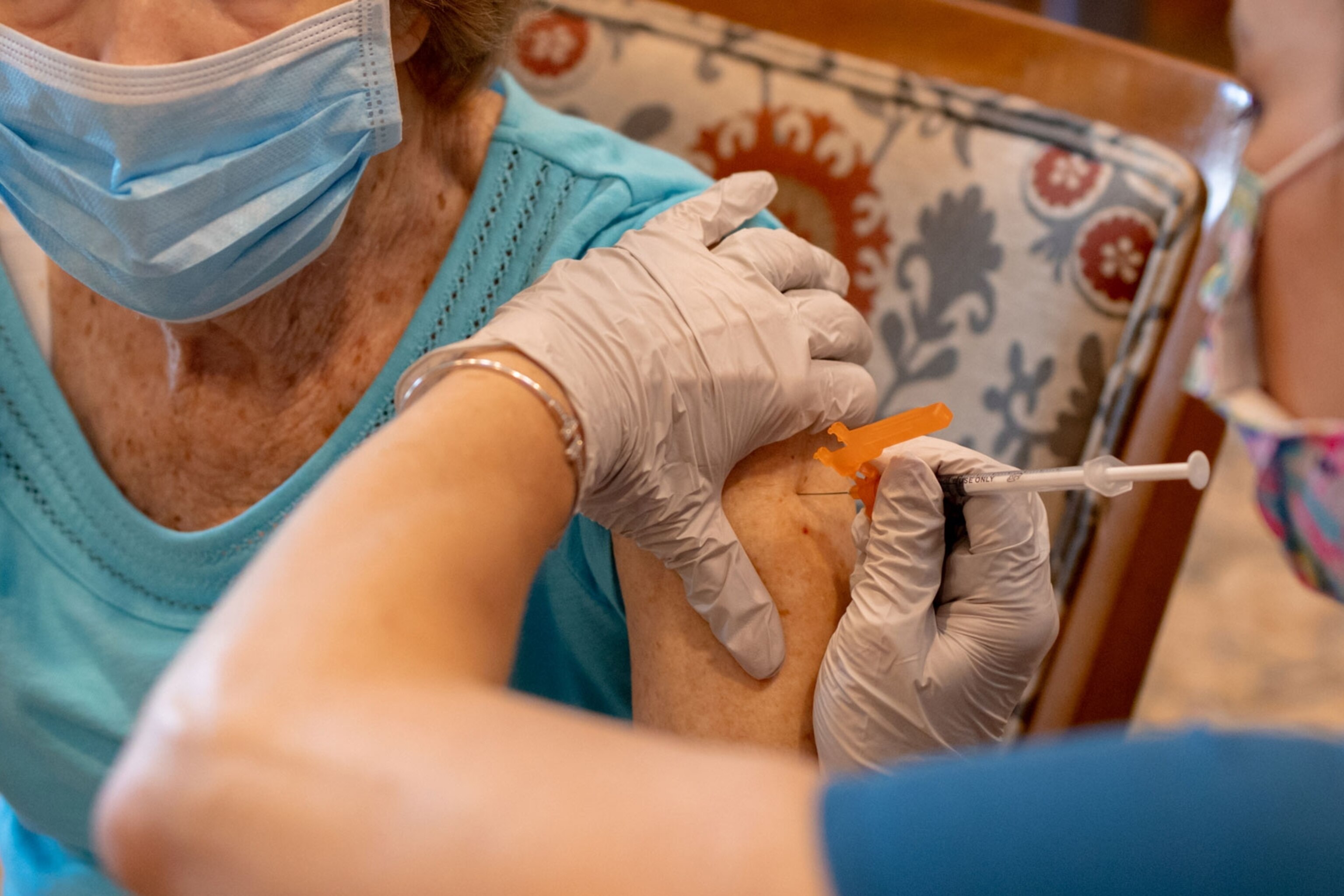 A healthcare worker administers a third dose of the Covid-19 vaccine in Pennsylvania.