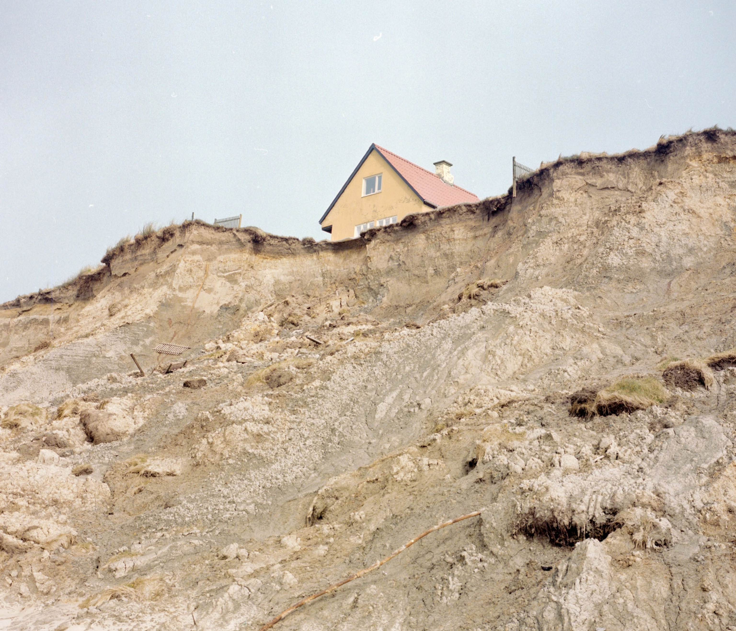 house on very edge of cliff.