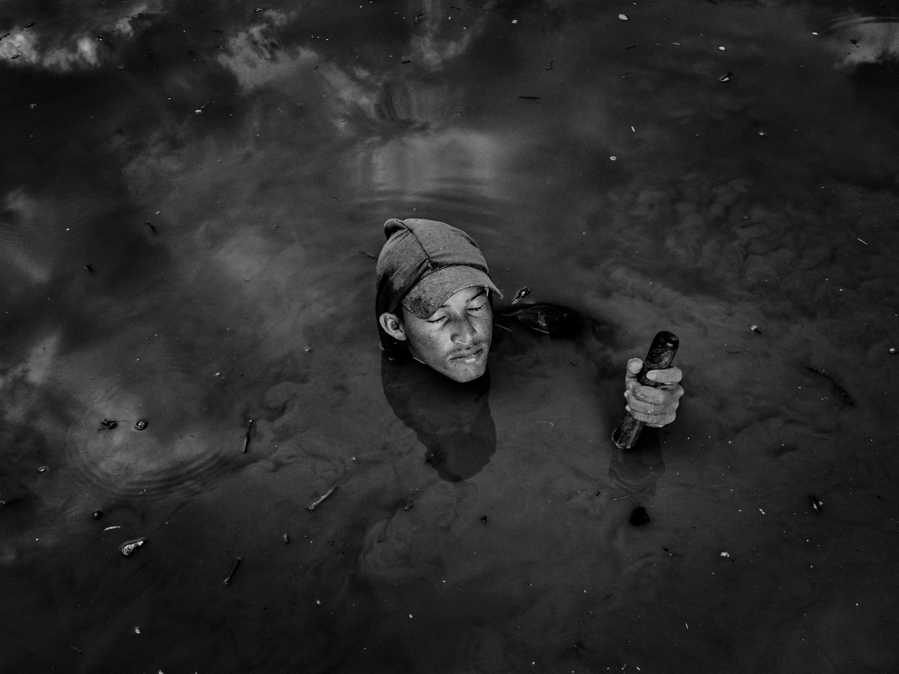 a man gathering soil samples in a swamp in Colombia