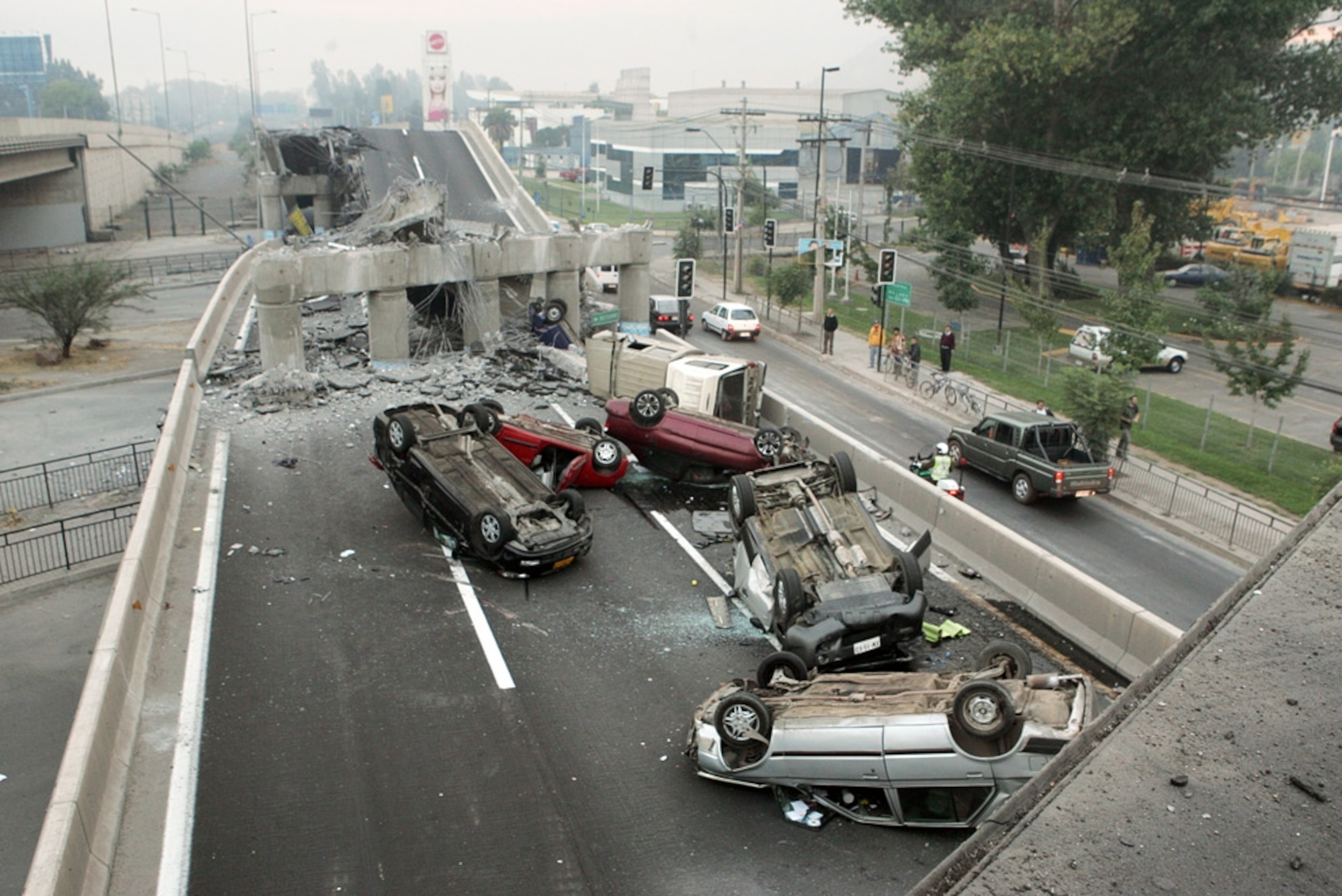 Damaged bridges and many upside-down cars are seen in a picture of a highway near Santiago, likely caused by the February 27, 2010, Chile earthquake.