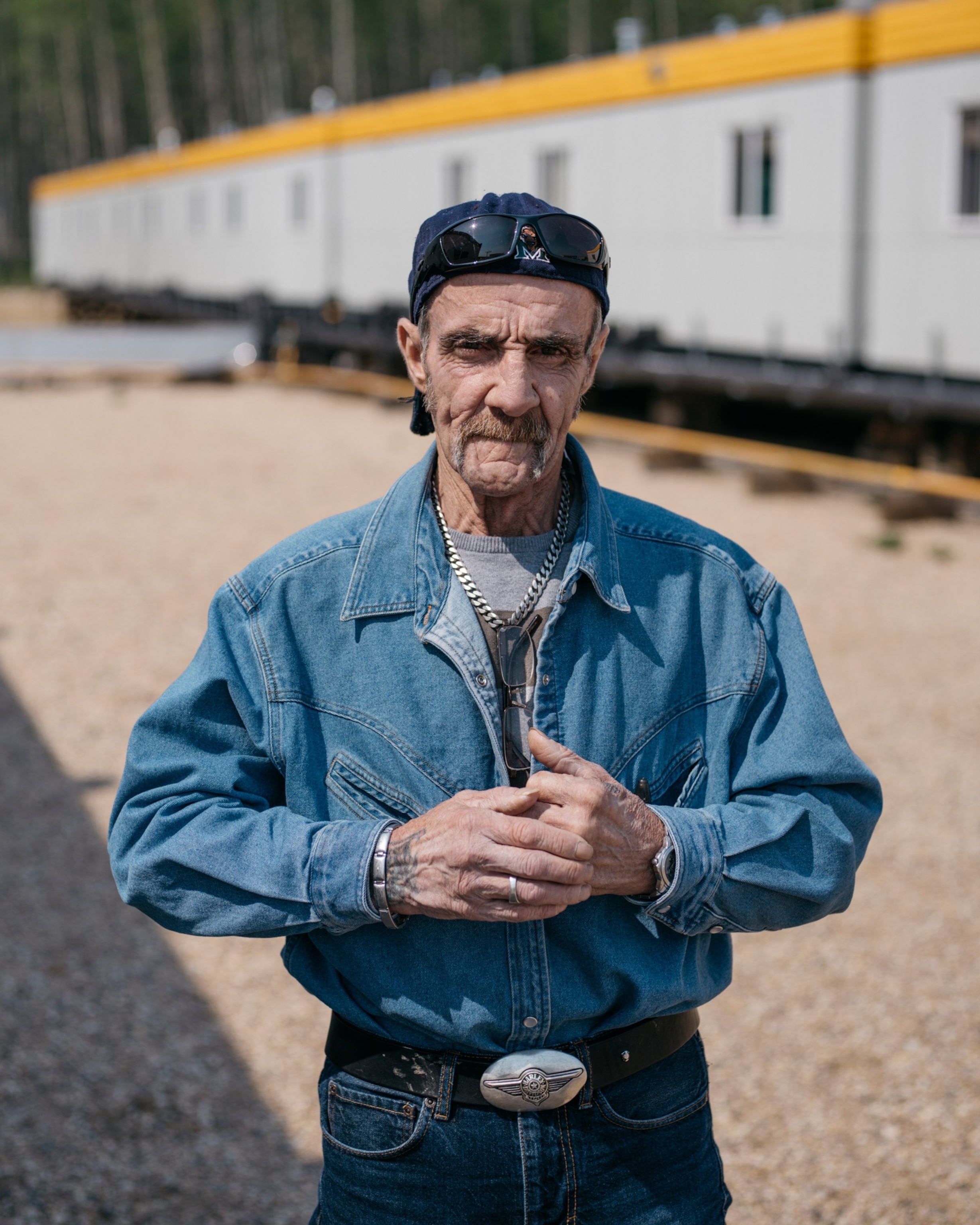 a man wearing a denim shirt
