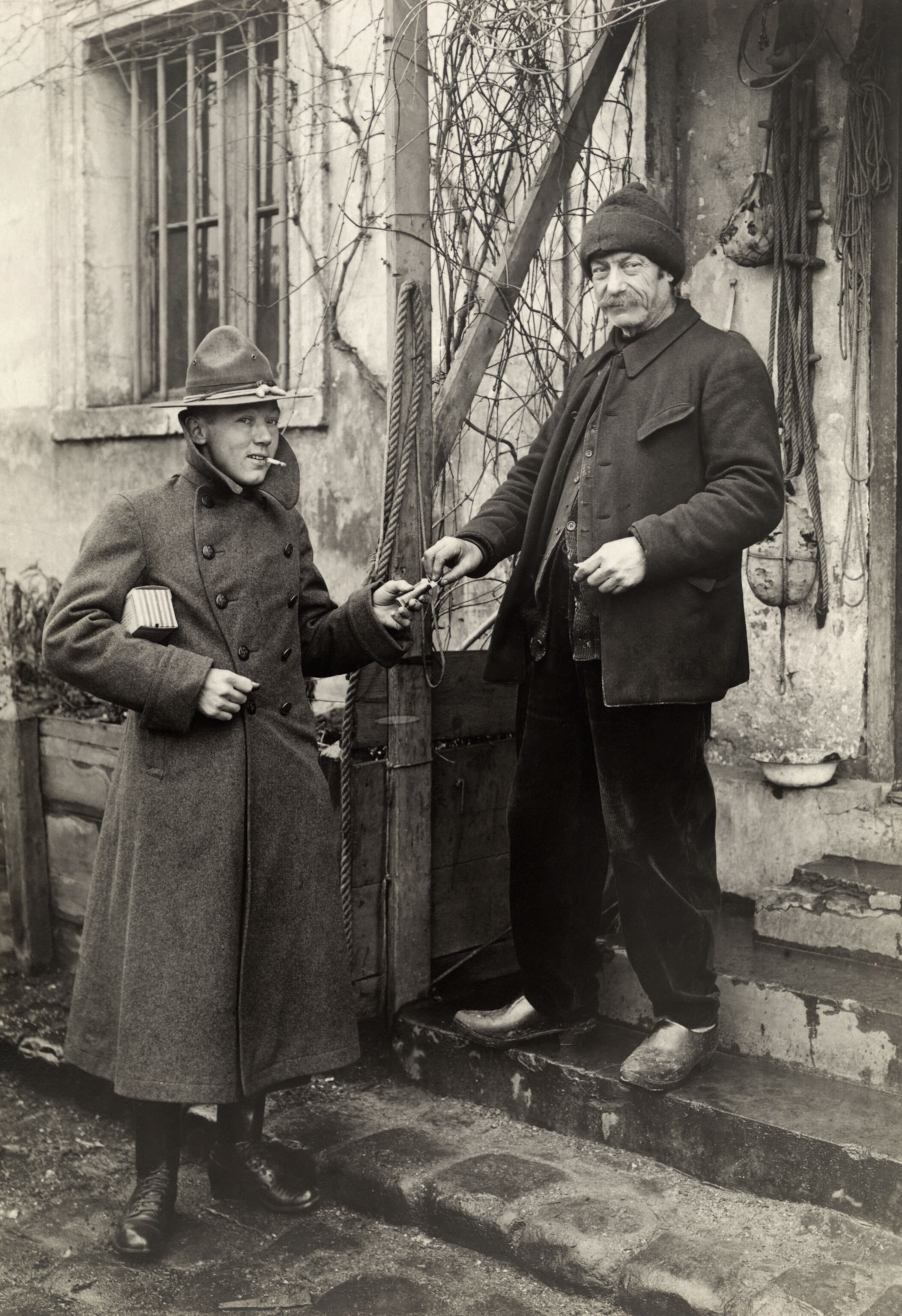 a soldier and a local in France smoking together