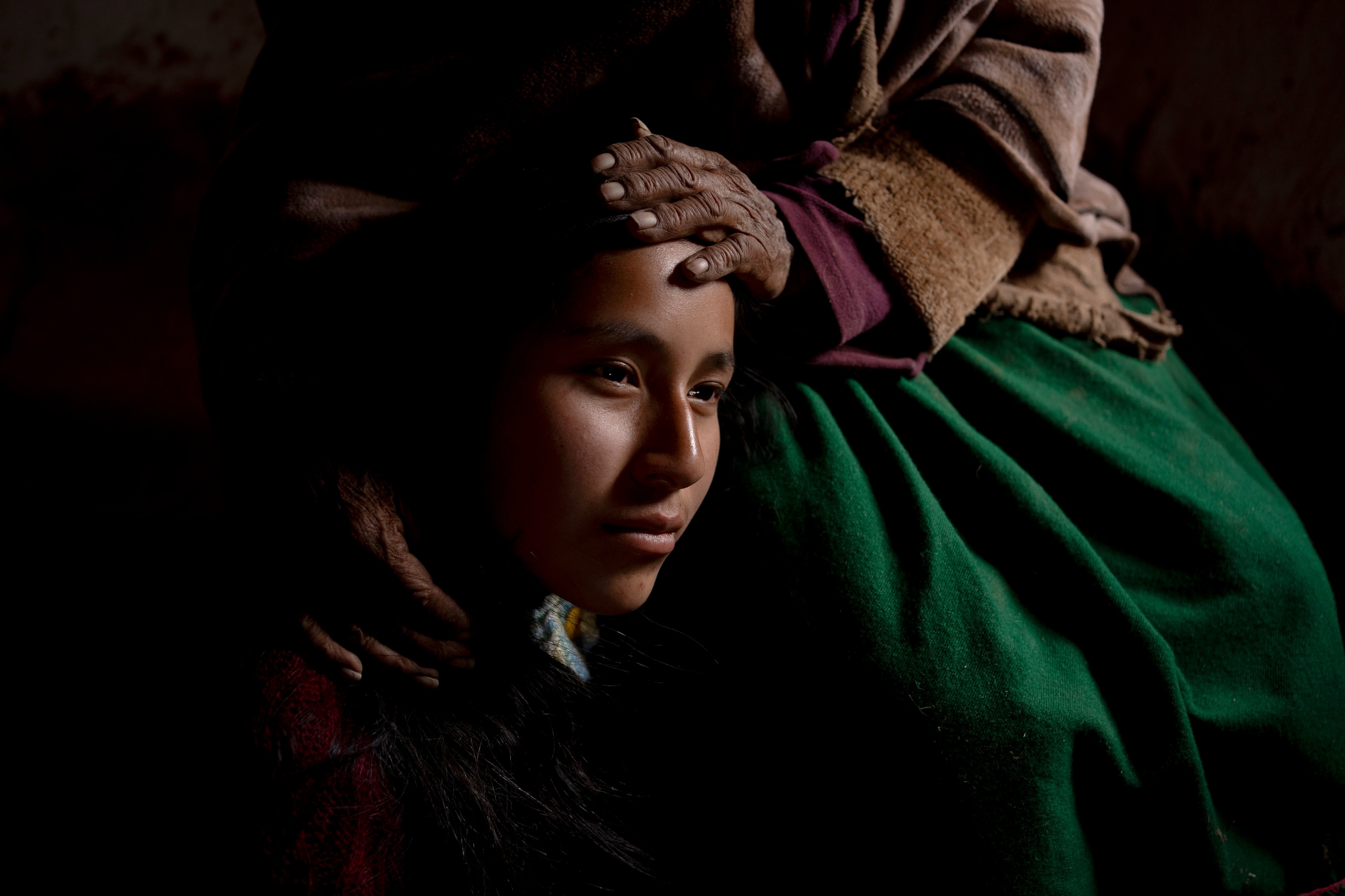 Portrait of Heydi Marcela Zarate held by her maternal grandmother, Maria Sánchez de la Cruz, in her hometown of San José, in the province of Azángaro, Puno, Peru. Heydi recently finished her secondary studies in the village of Phinaya and decided to move to Cusco to study Environmental Engineering in the Universidad Nacional de San Antonio Abad del Cusco (UNSAAC). Drawing on the knowledge and legacy of her parents and grandparents, she hopes to return to her community to address challenges such as the climate crisis, which directly impacts the Quelccaya Glacier. Puno, 2023.