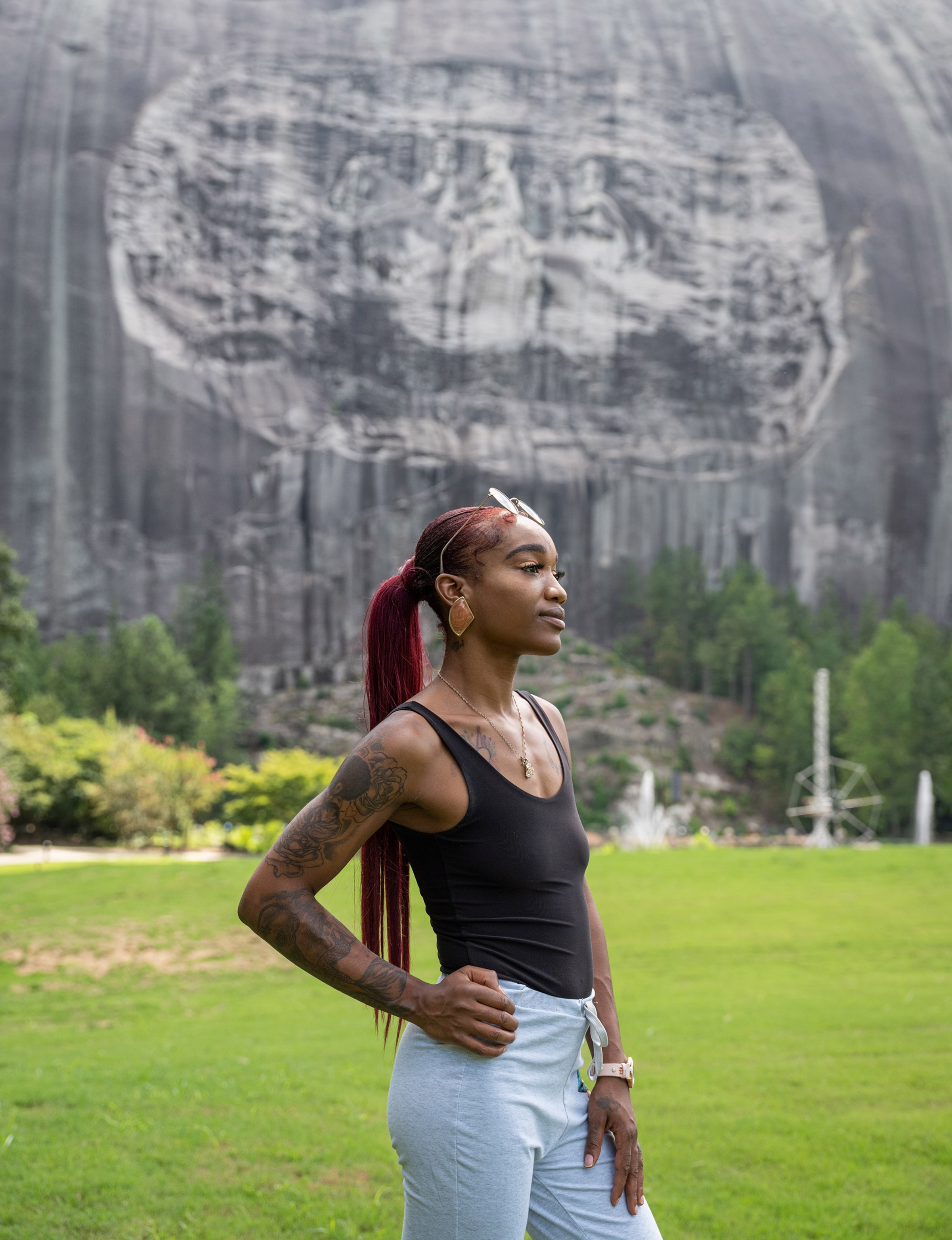a person standing for a portrait in front of the carving at Stone Mountain Park in Georgia