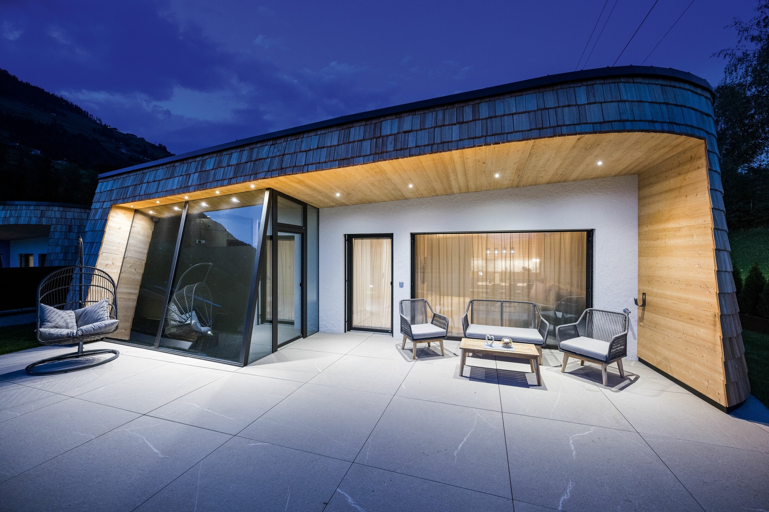 The outside of a futuristic-rustic chalet at Dolomit Royal.
