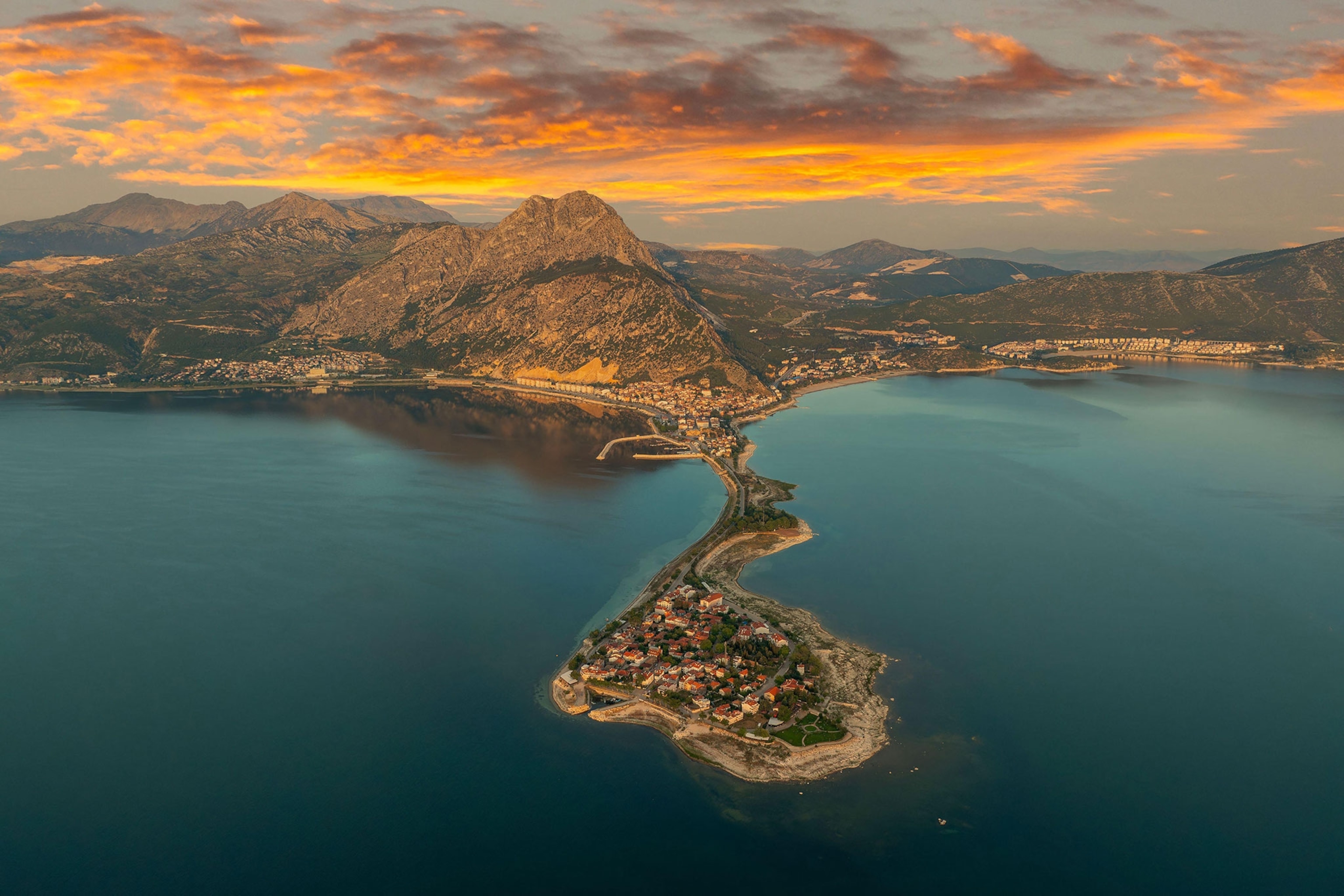 A wide view of a land surrounded by water.
