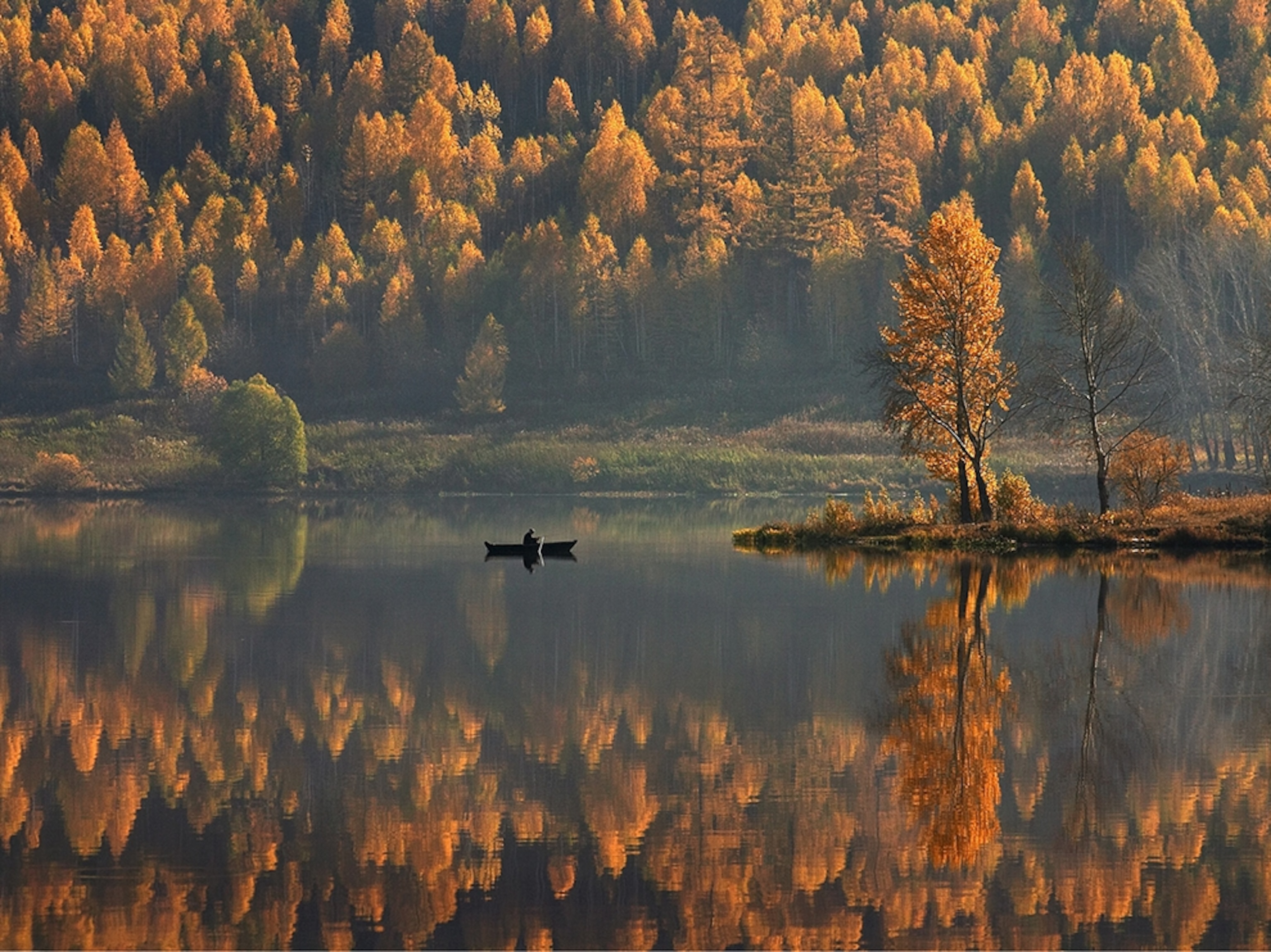 a canoe on a lake amid fall colors, Satka, Russia