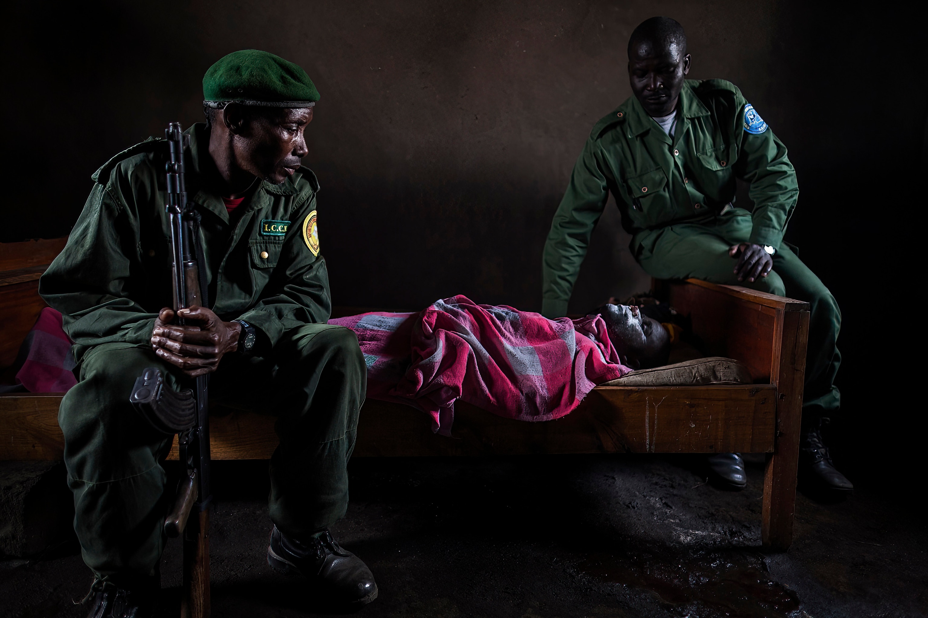 two rangers sitting on a bed with another ranger who died after being shot