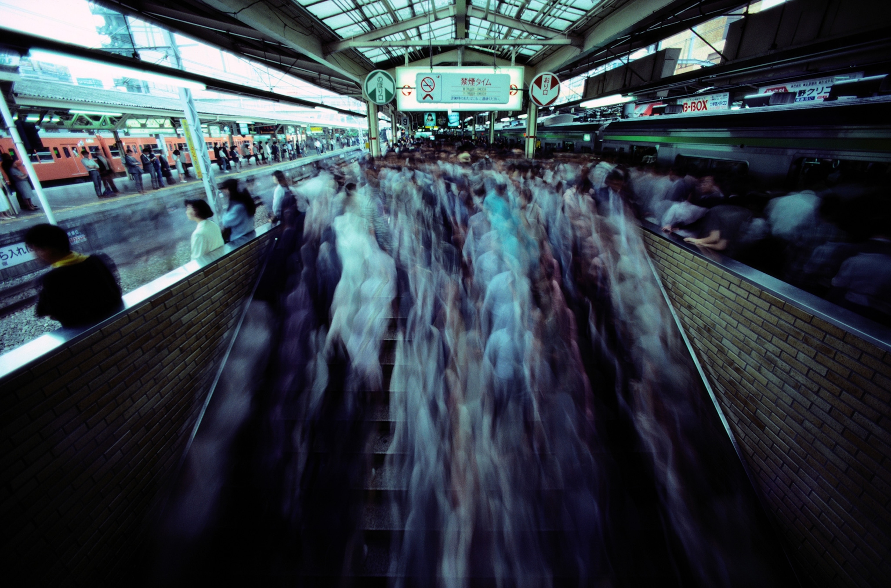 crowds moving about in a Japanese subway station