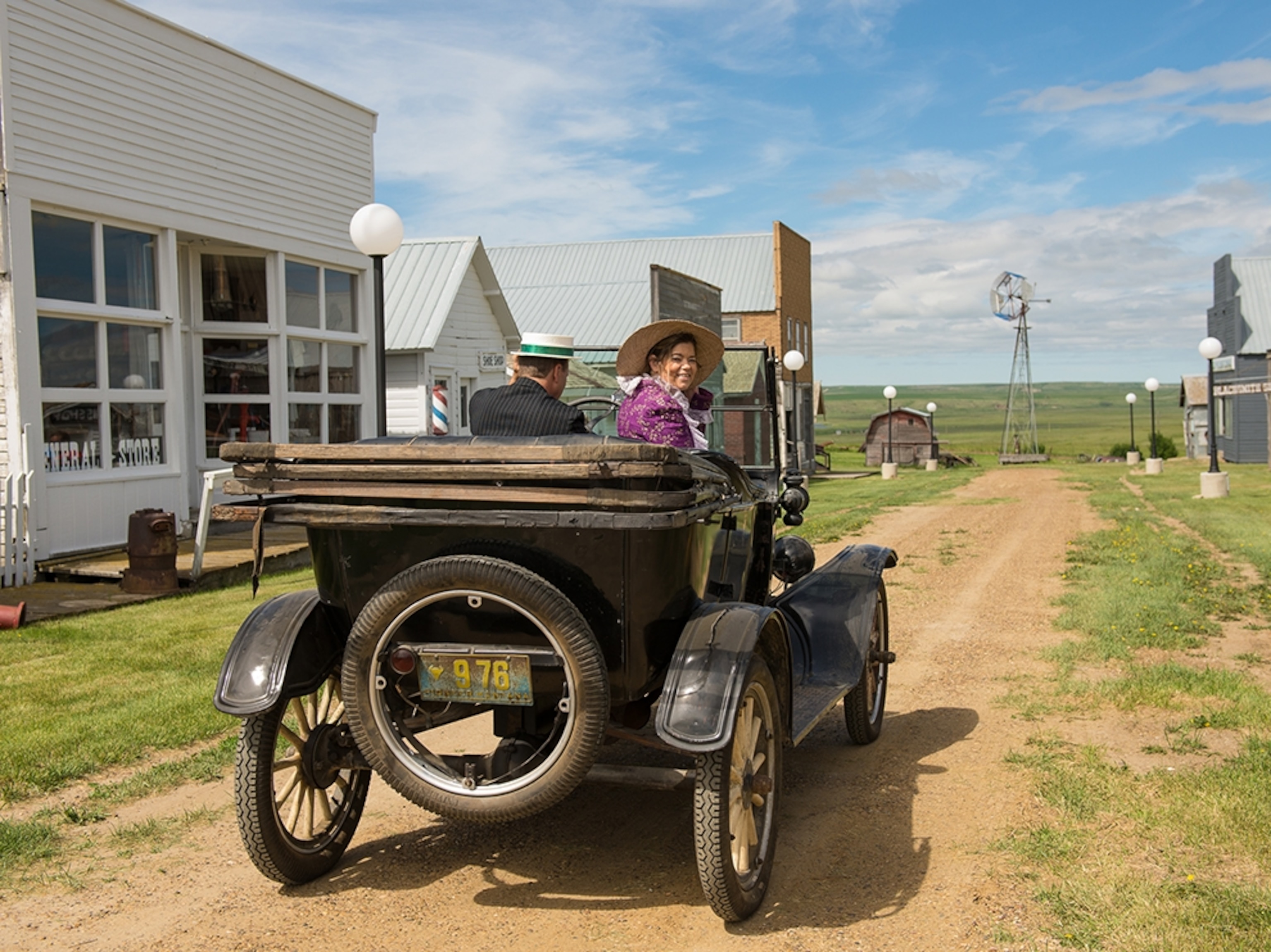 visitors driving through Scoby, Montana, in an old car