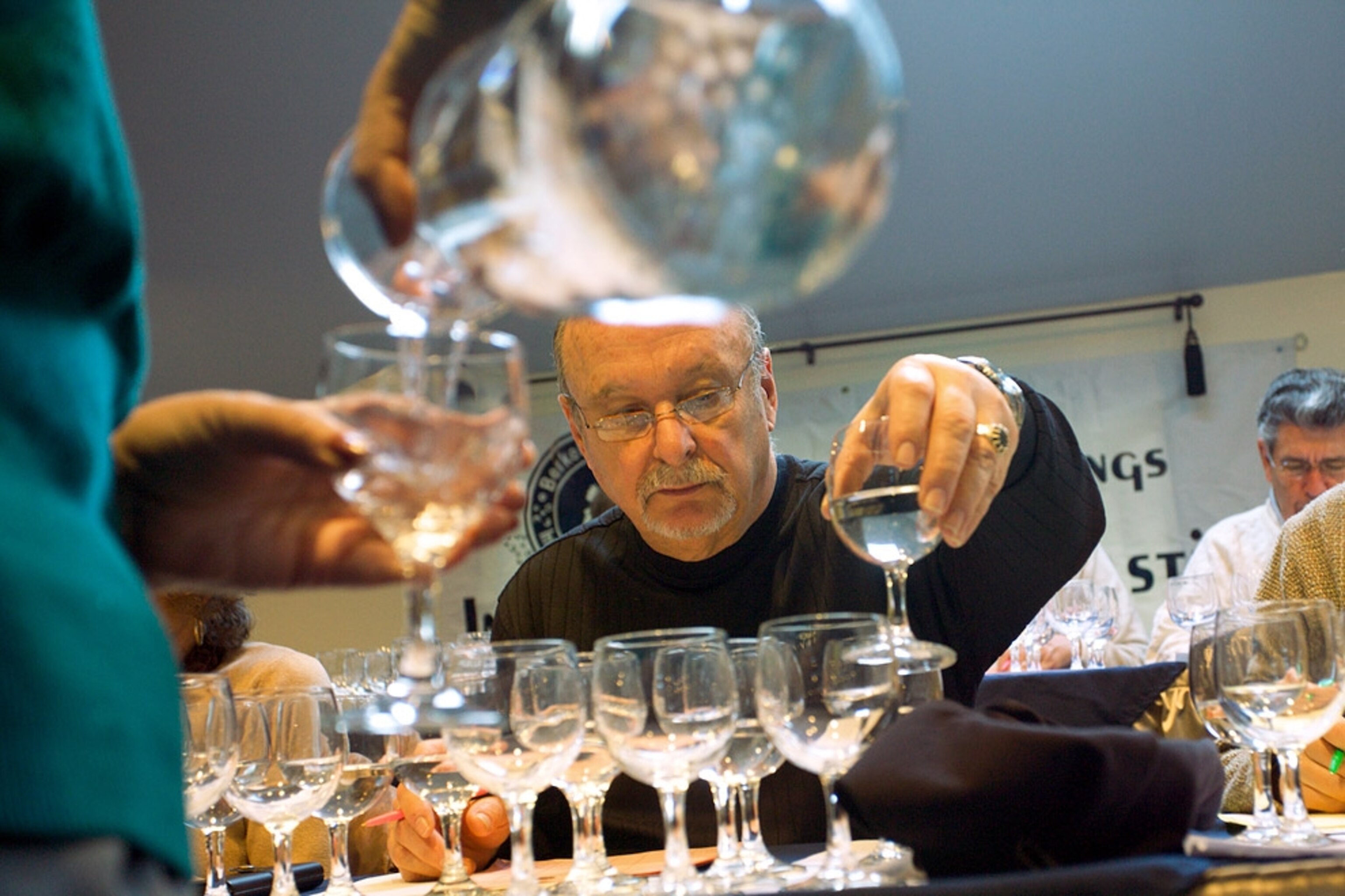 A man lifting a glass of water