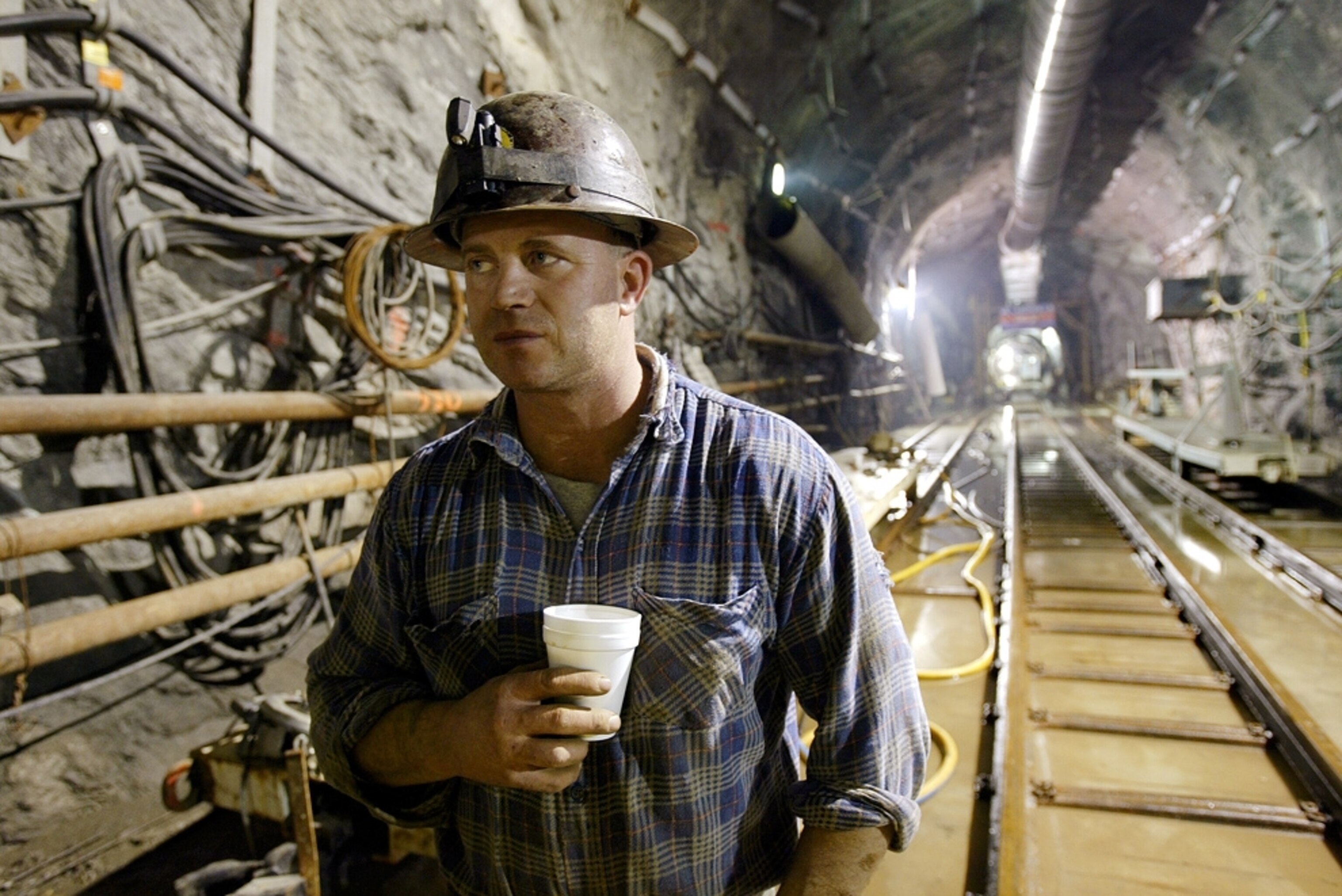 A worker takes a break in a tunnel