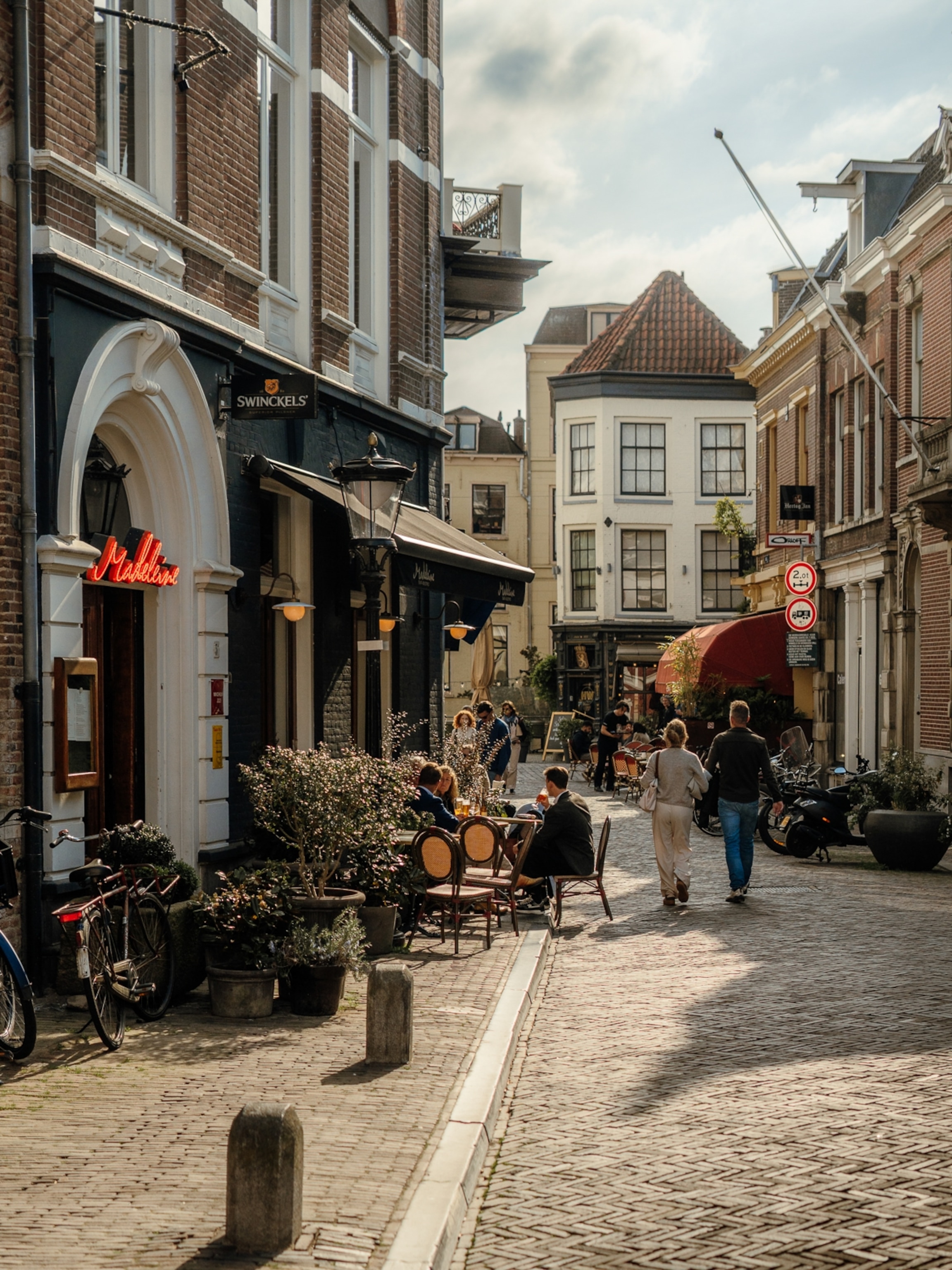 A sunlit cobblestone street in Utrecht, Netherlands.