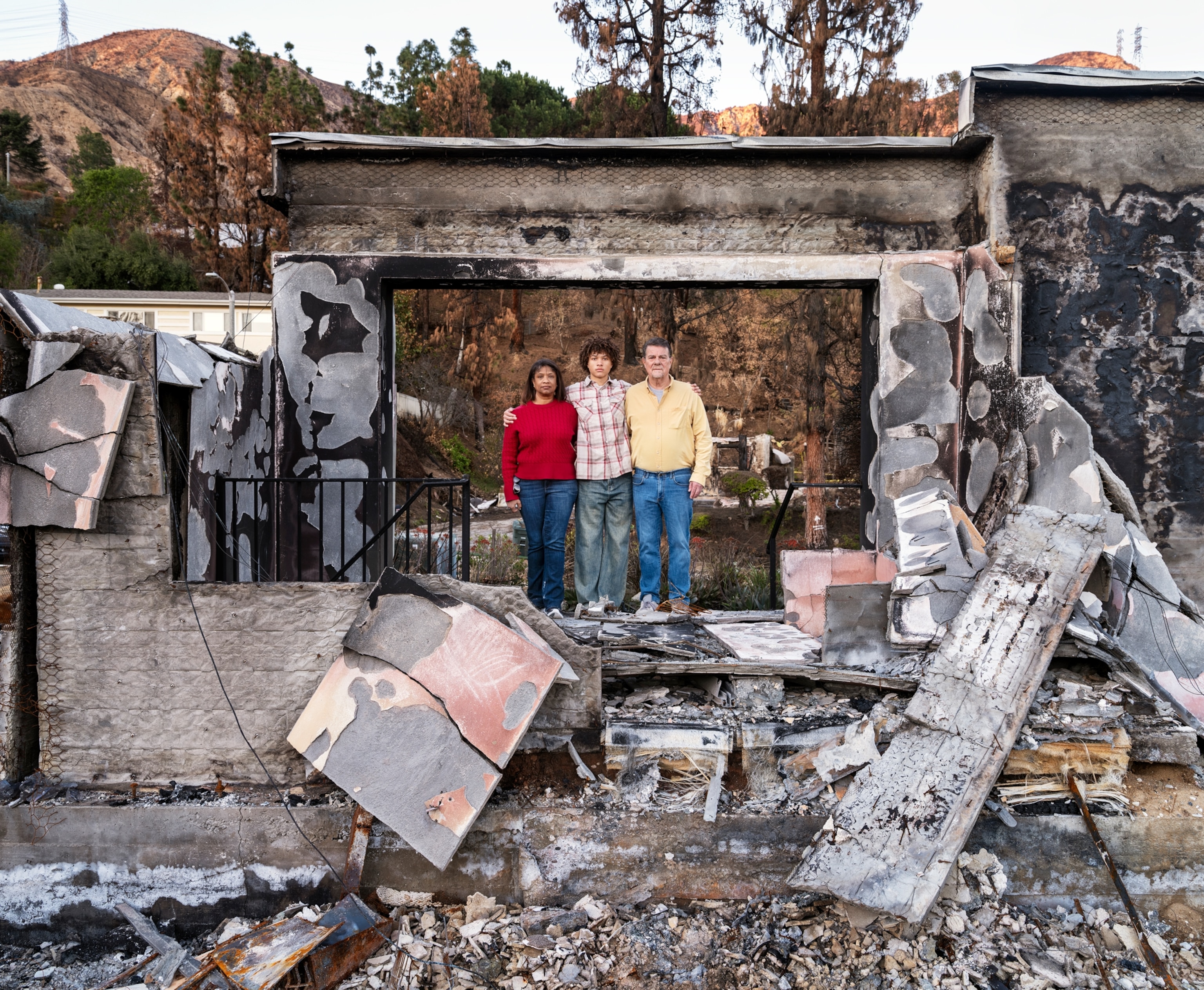MARLA PEPPERS, RYAN SHOOP, AND RICK SHOOP Standi in the ruins from the LA Fires.