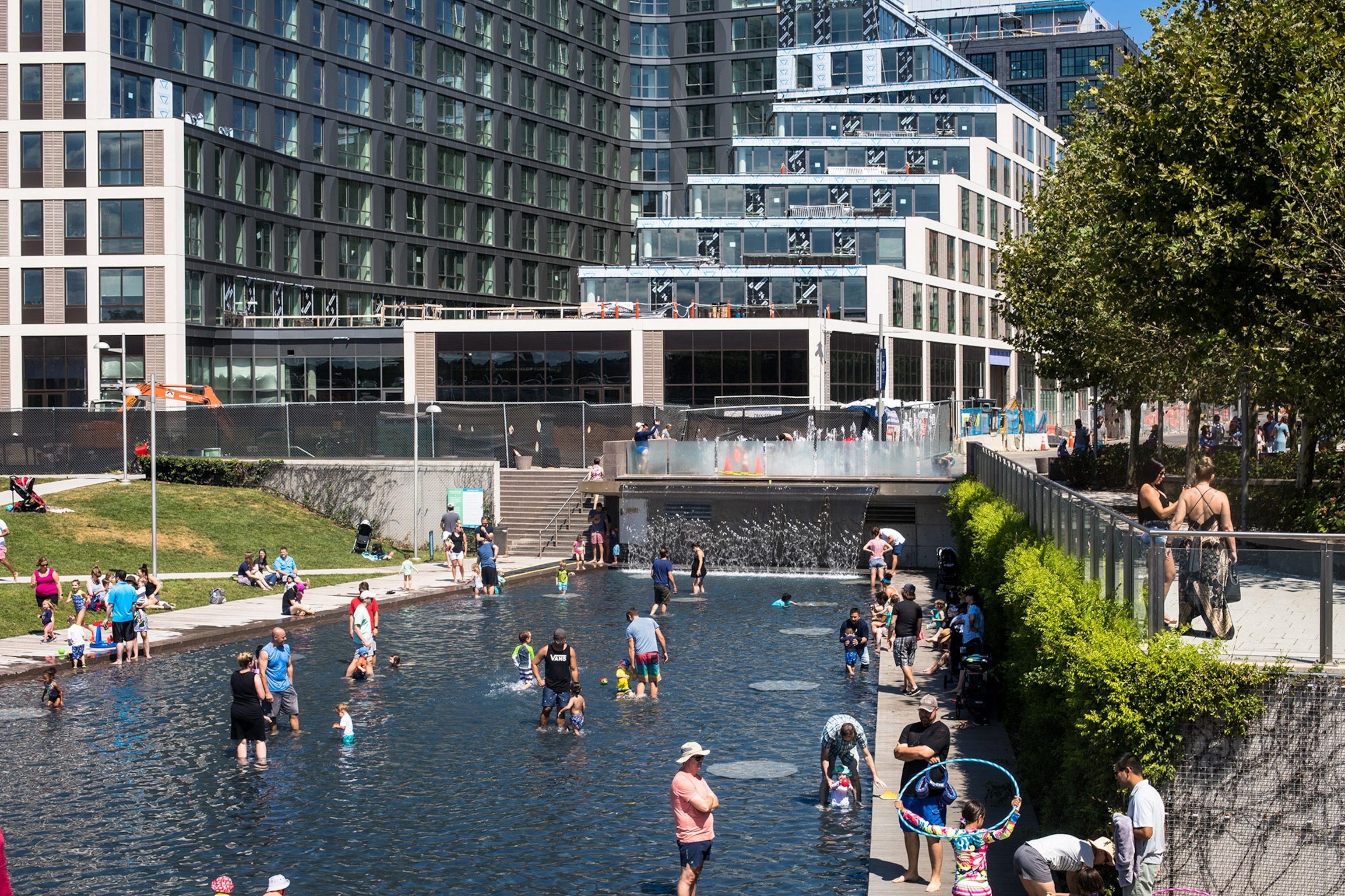 People stand in water in front of a building.