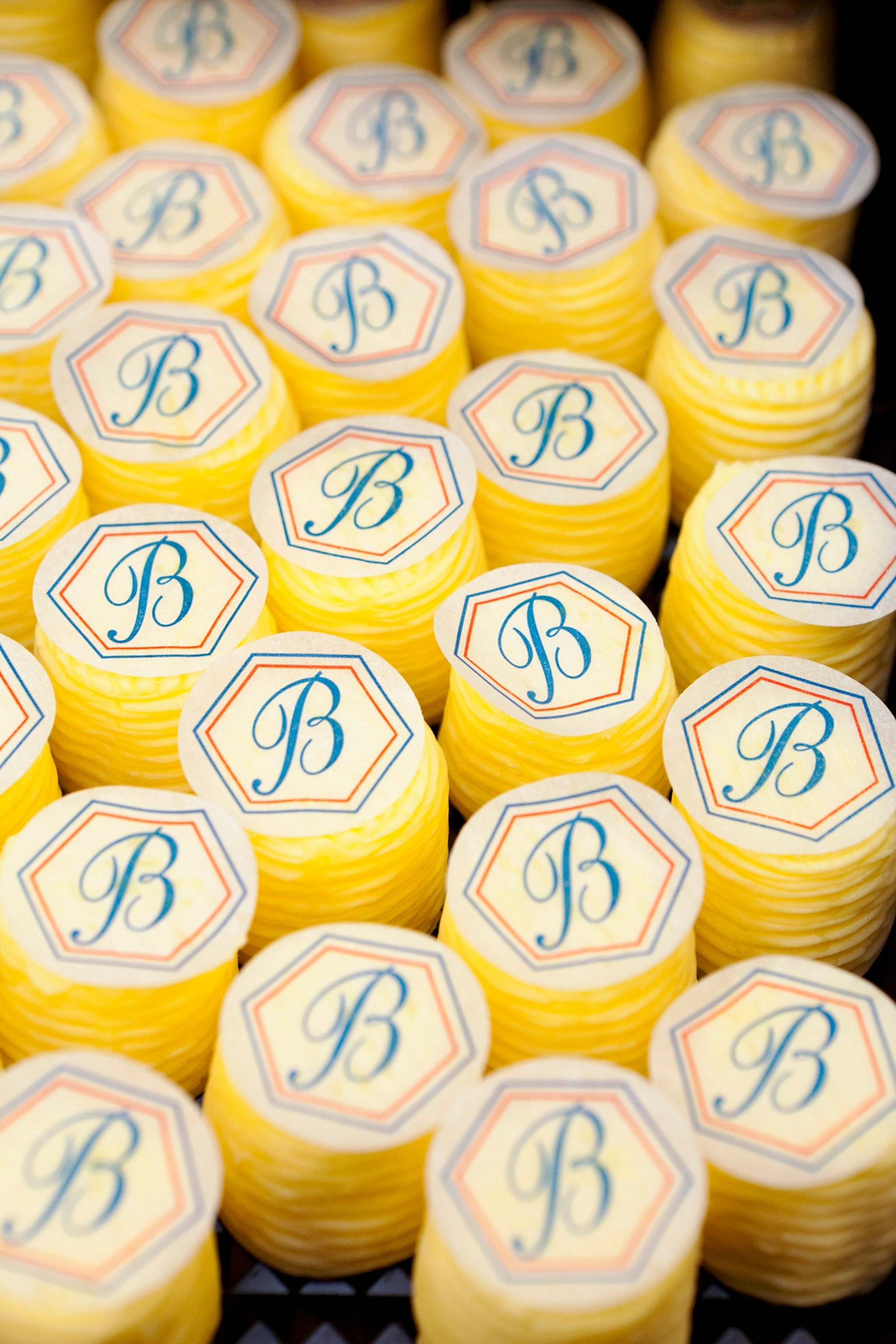 France, Brittany, St Malo, Europe, April 2014. Round pieces of butter, stamped and labelled, French butter maker Jean-Yves Bordier, food production, economy, manufactory, craft, travel