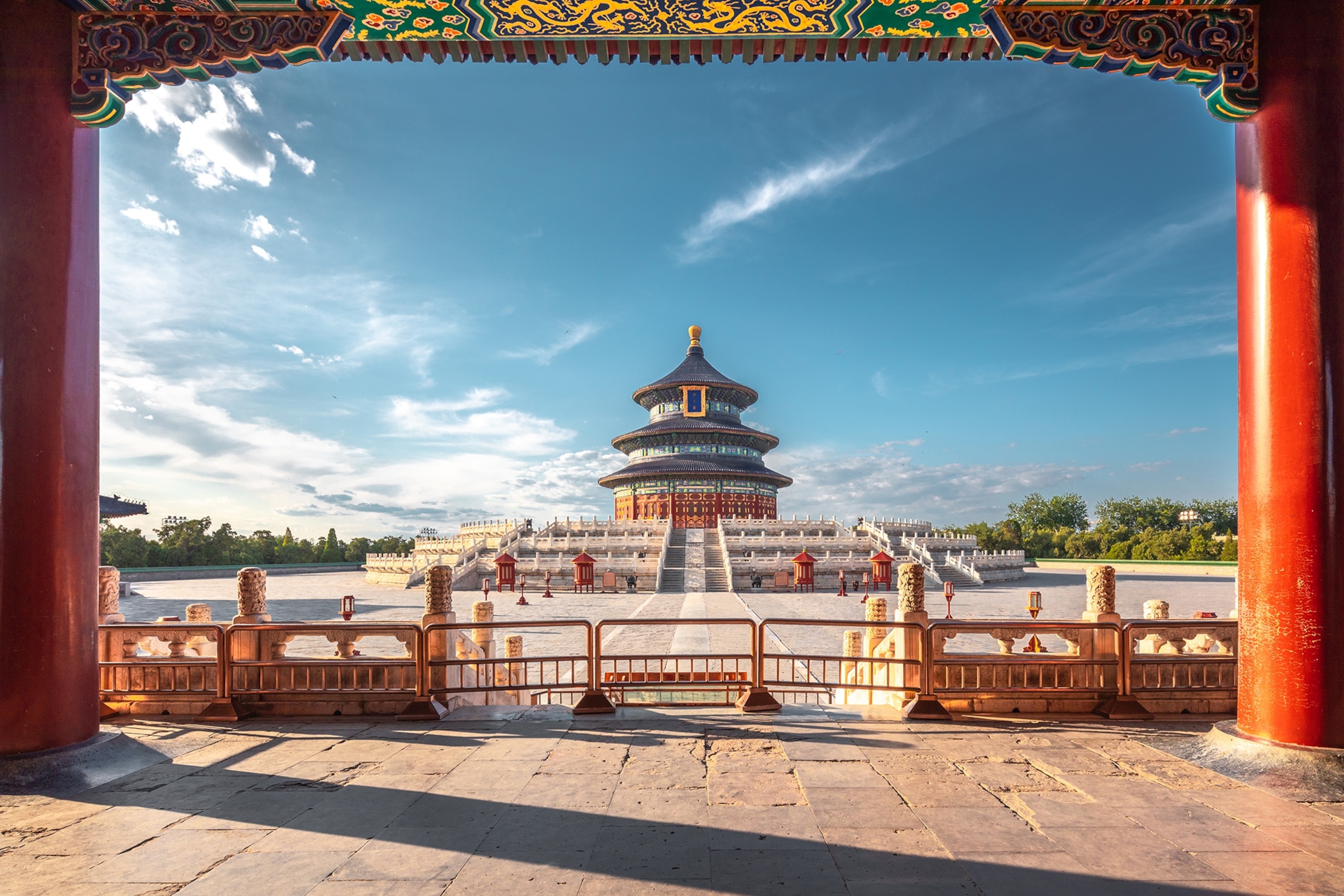 A framed view through one temple gate onto a plaza and second temple building straight ahead.