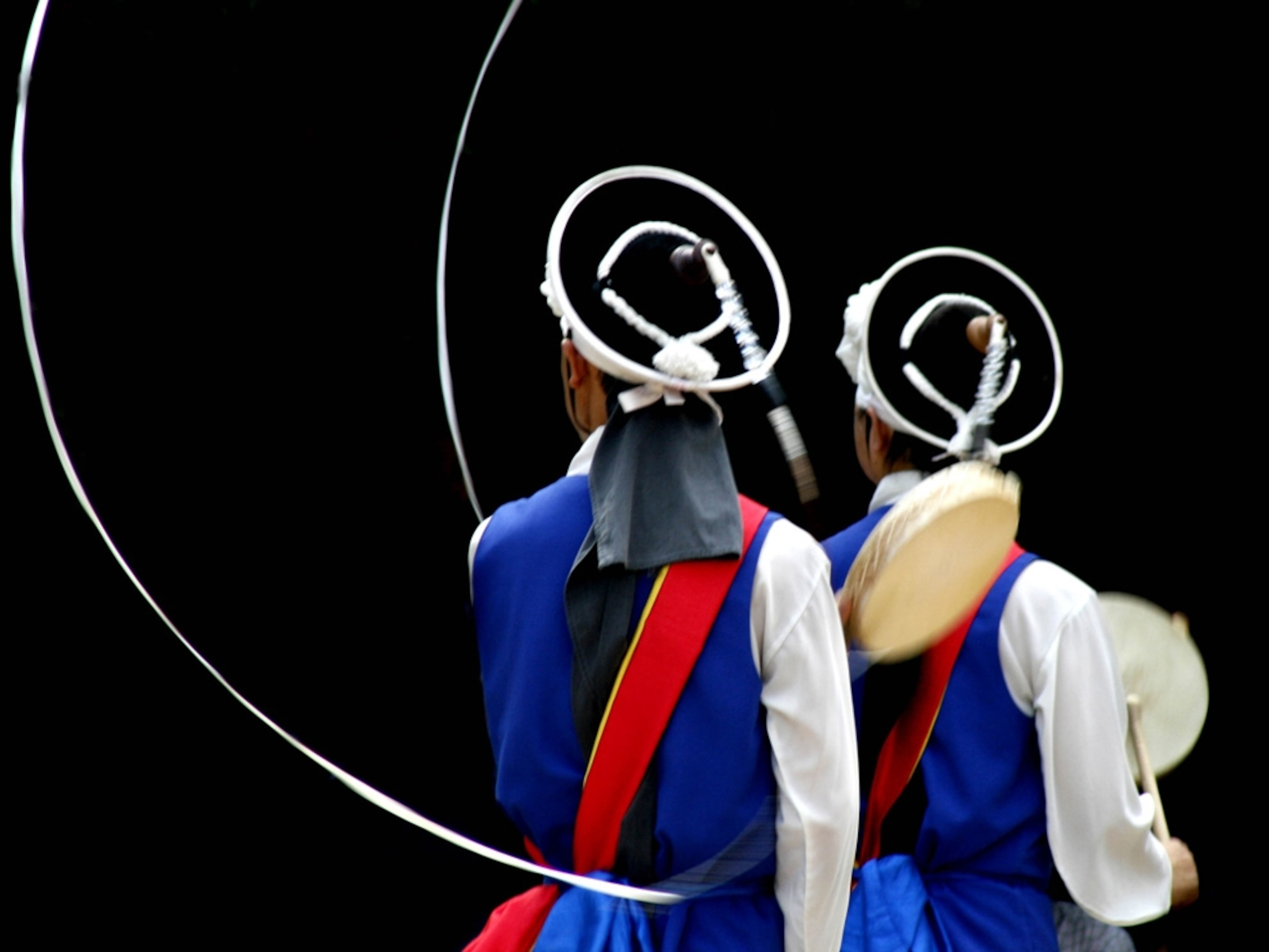 Two people in colorful costumes at a traditional celebration