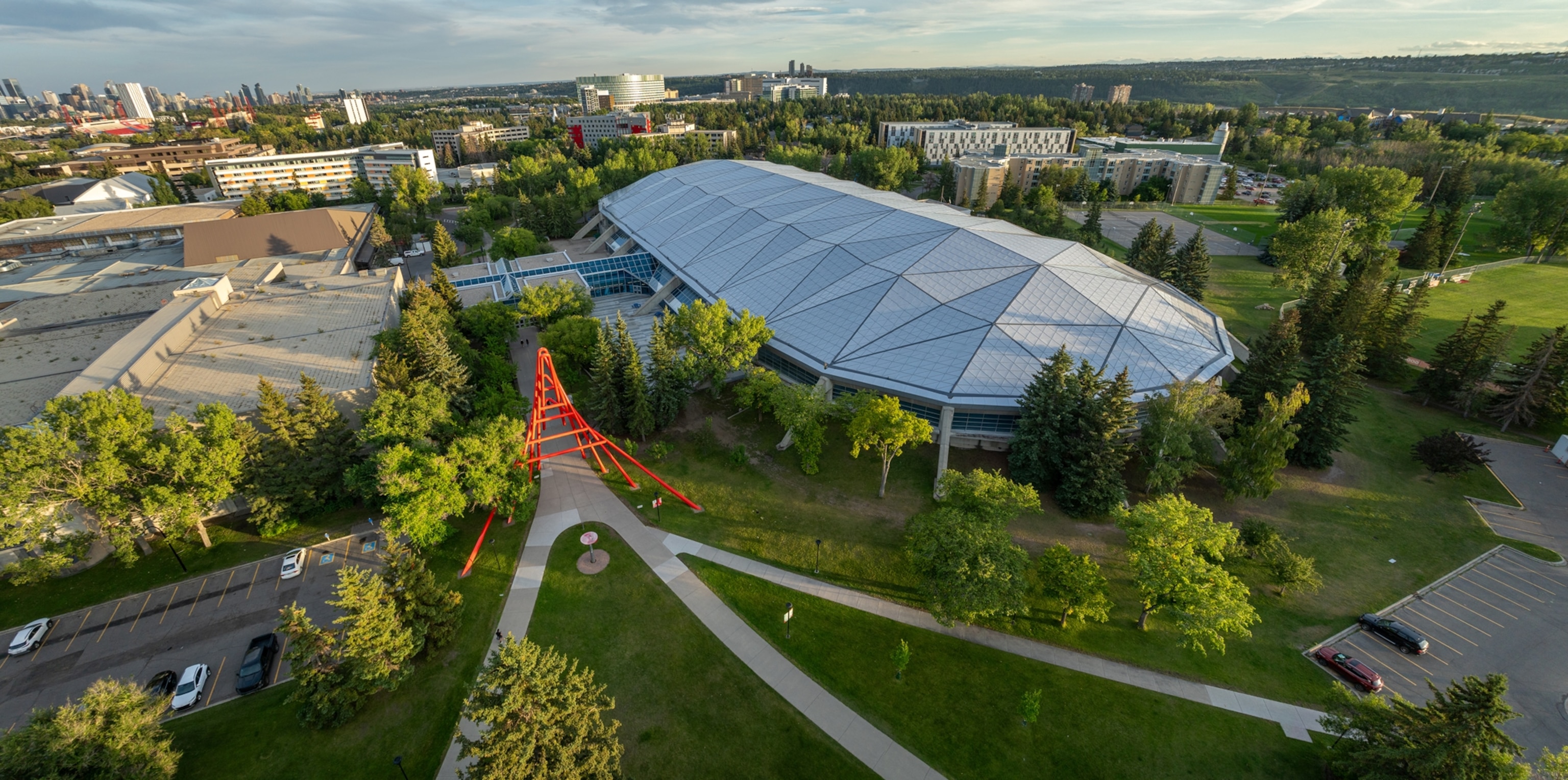 A birds eye view of a large dome building among grass and other buildings