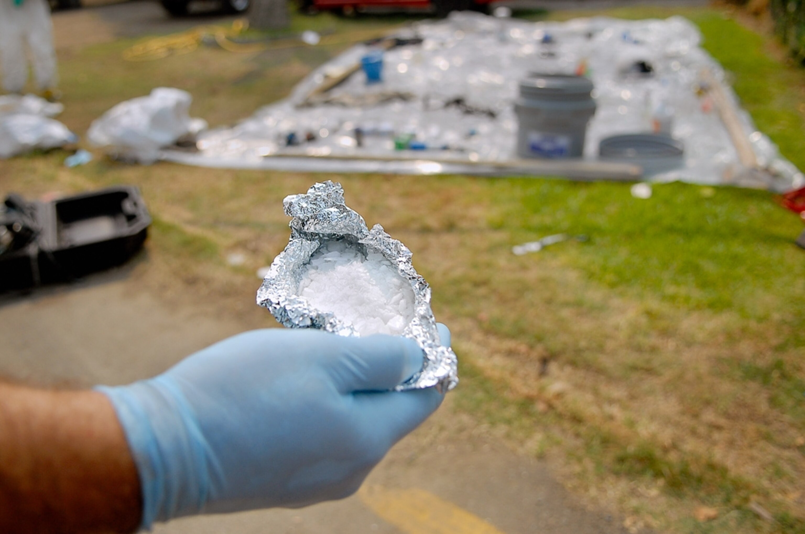 A Yuba City police officer displays a cache of methamphetamine found during a raid on a suspected meth lab in Yuba City, Calif., Wednesday, Sept. 5, 2007.