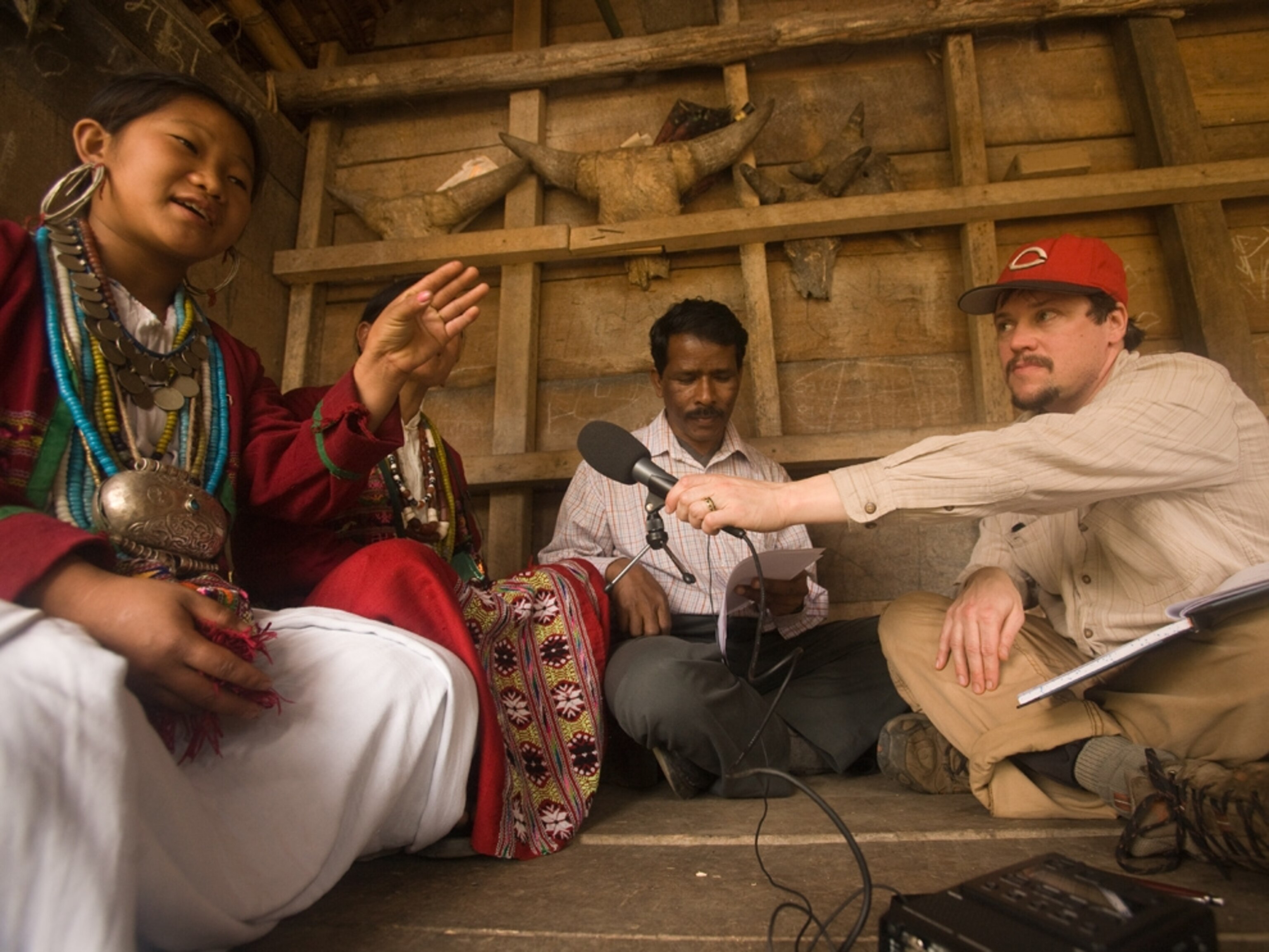 Greg Anderson and Ganesh Murmu interview a woman (name withheld) from the Aka tribal group