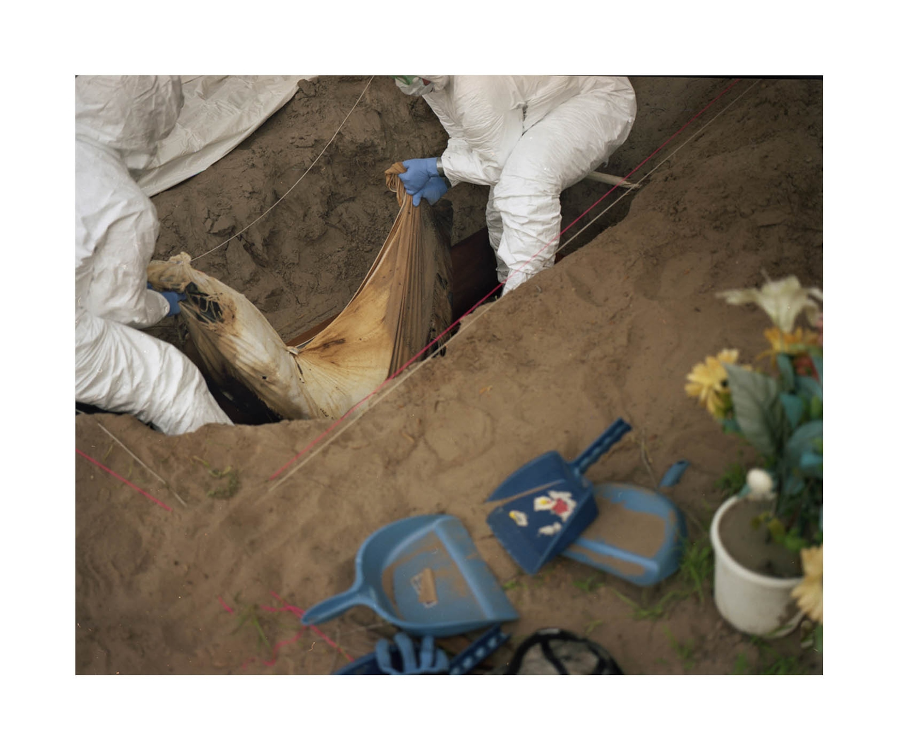 men lowering body bag