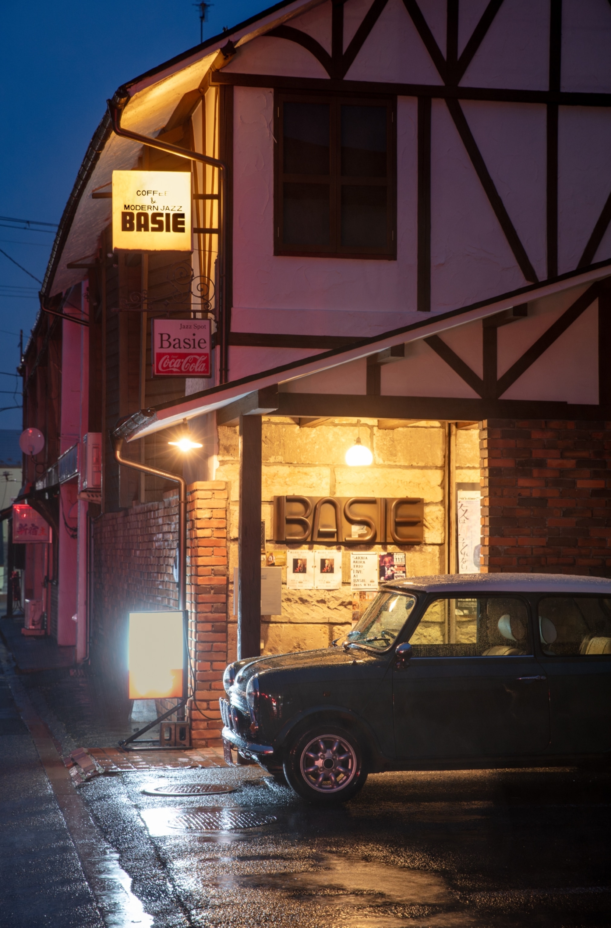 Exterior of a jazz club on a rainy night.