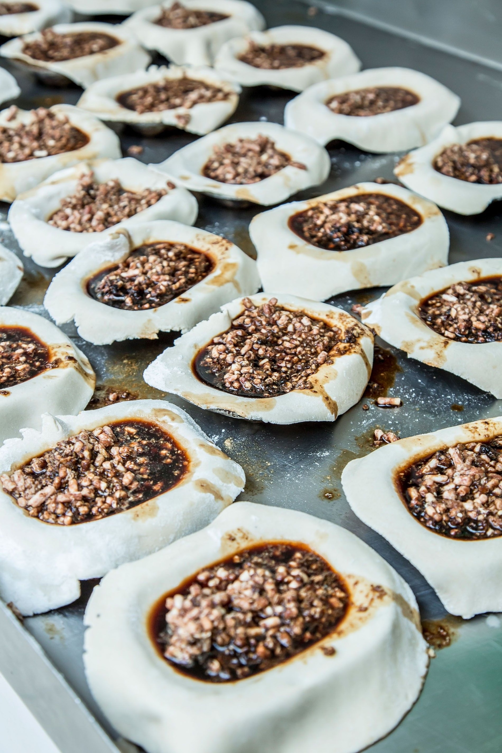 The pastry is shaped into individual pie tins