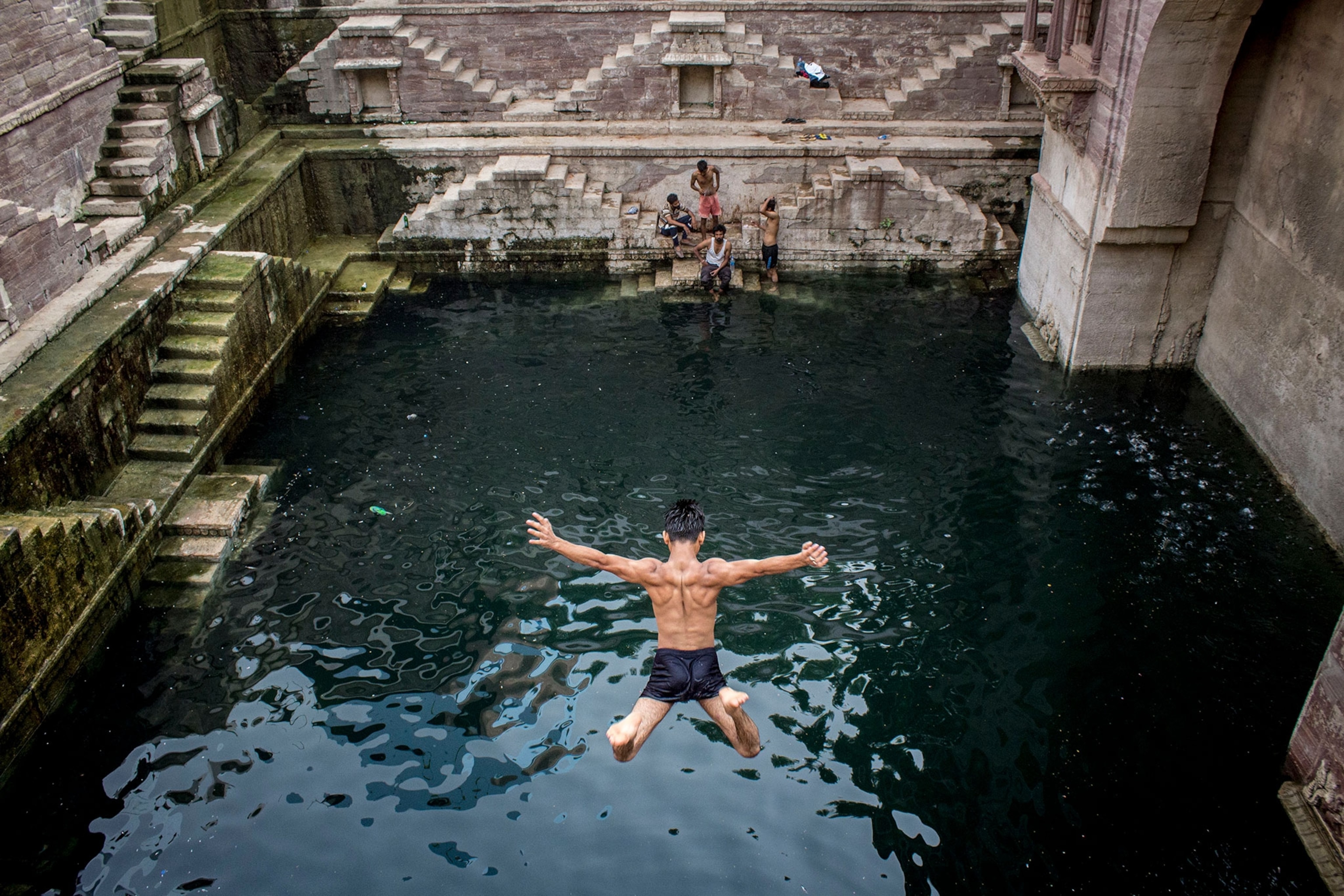 a man jumping into a stepwell