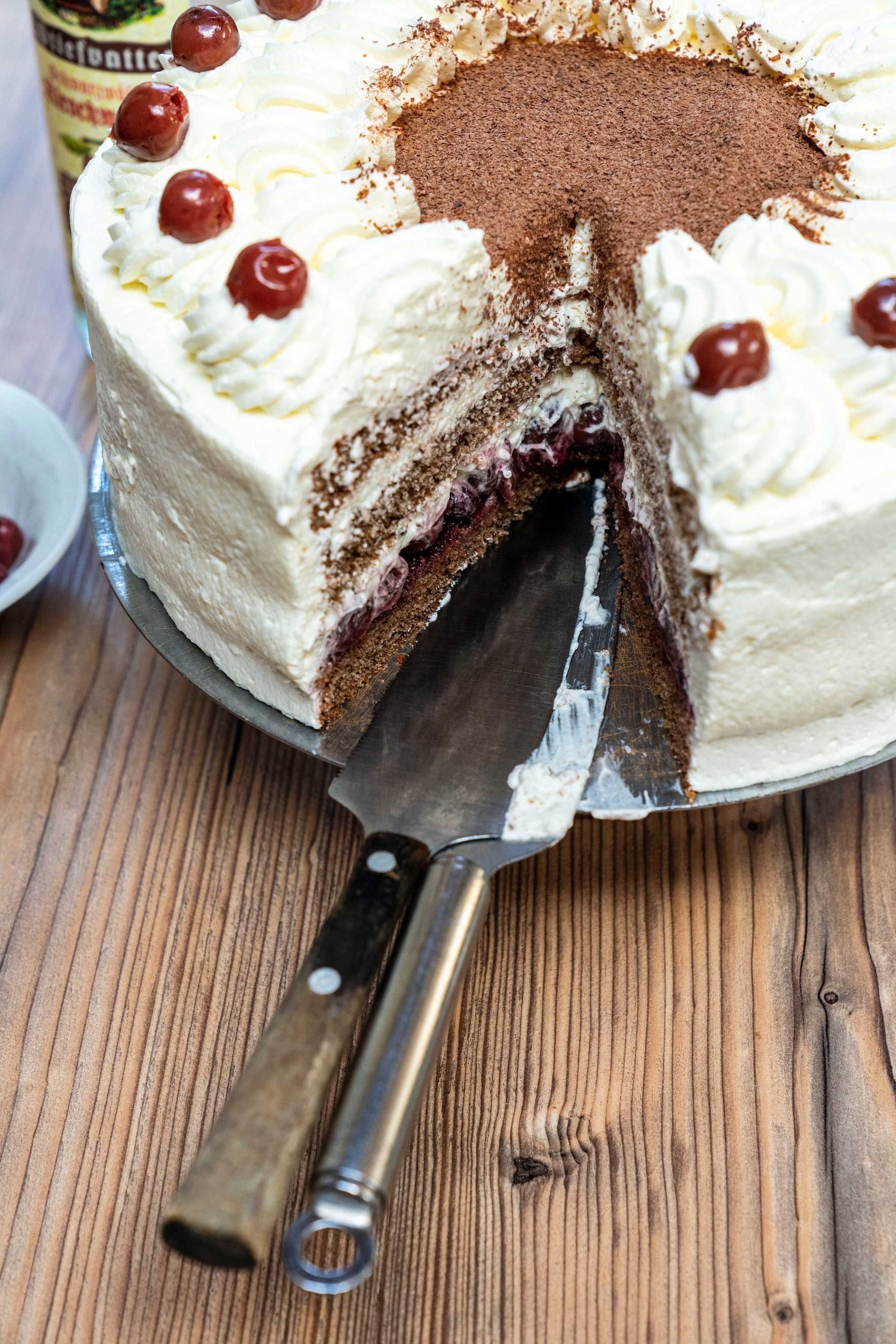 A black forest gateaux, a cake with fresh cream and cherries in layers.