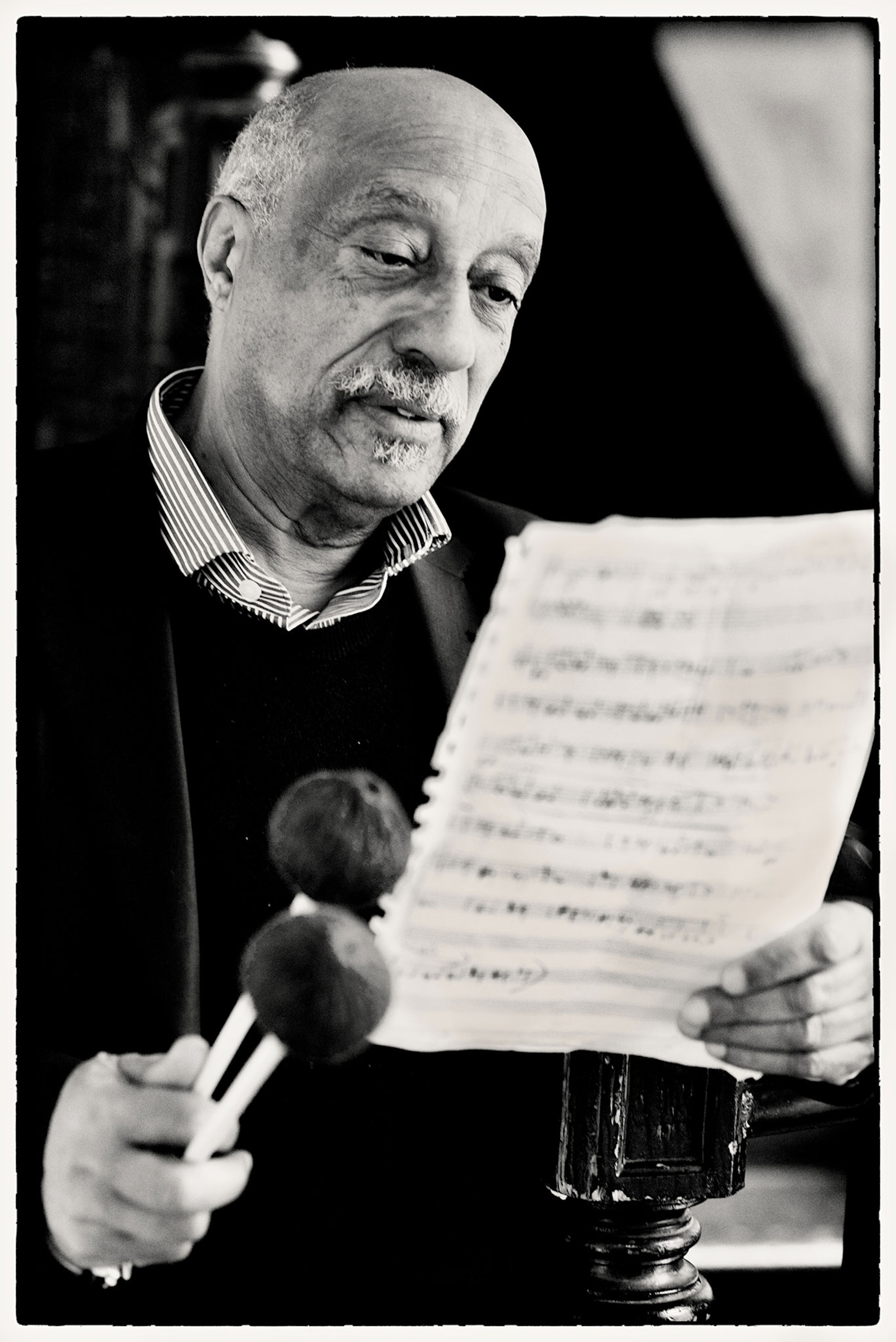 A man reads sheet music.