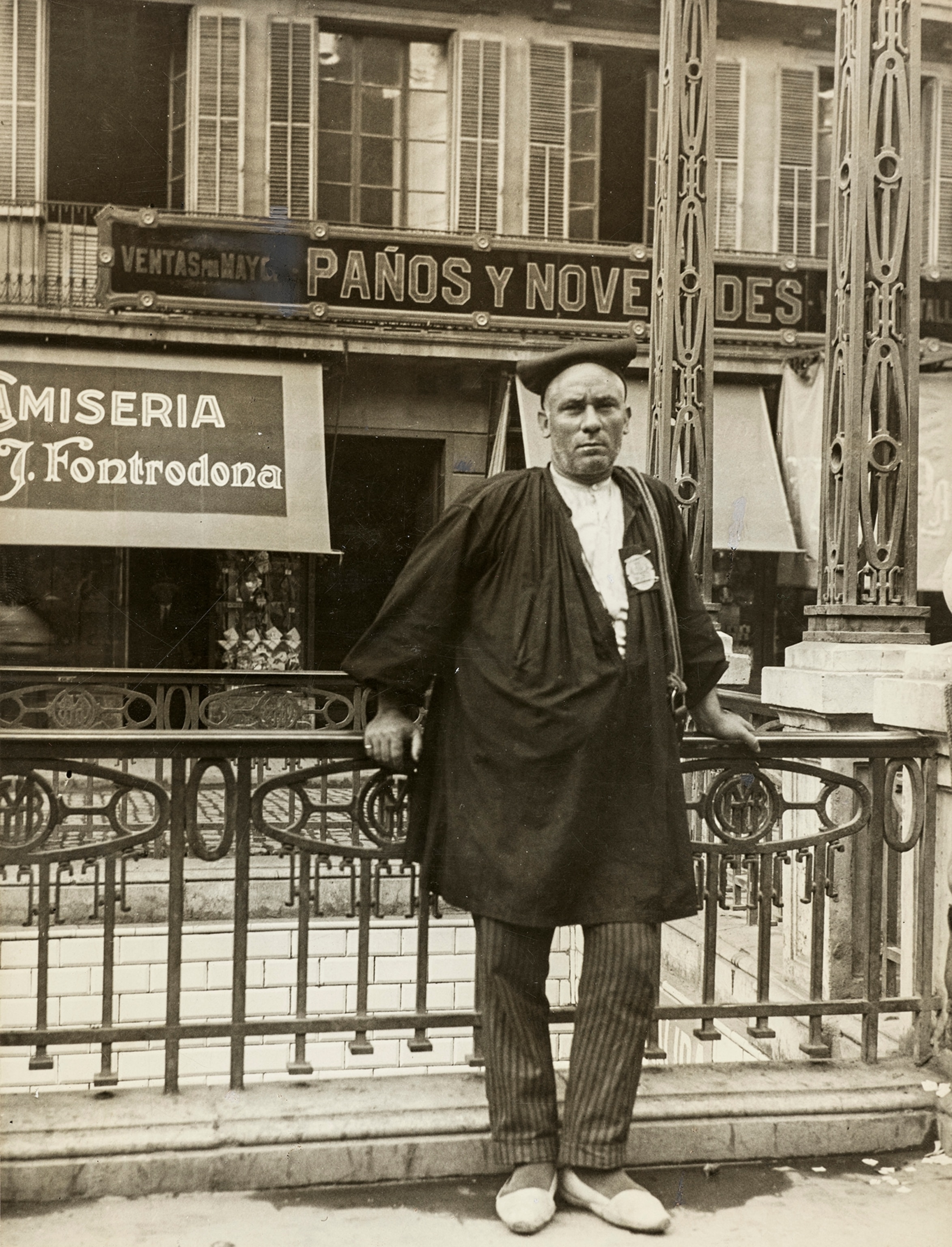 A portrait of a mozo de cuerda (porter), the Red Cap of the city, wearing his barretina cap.