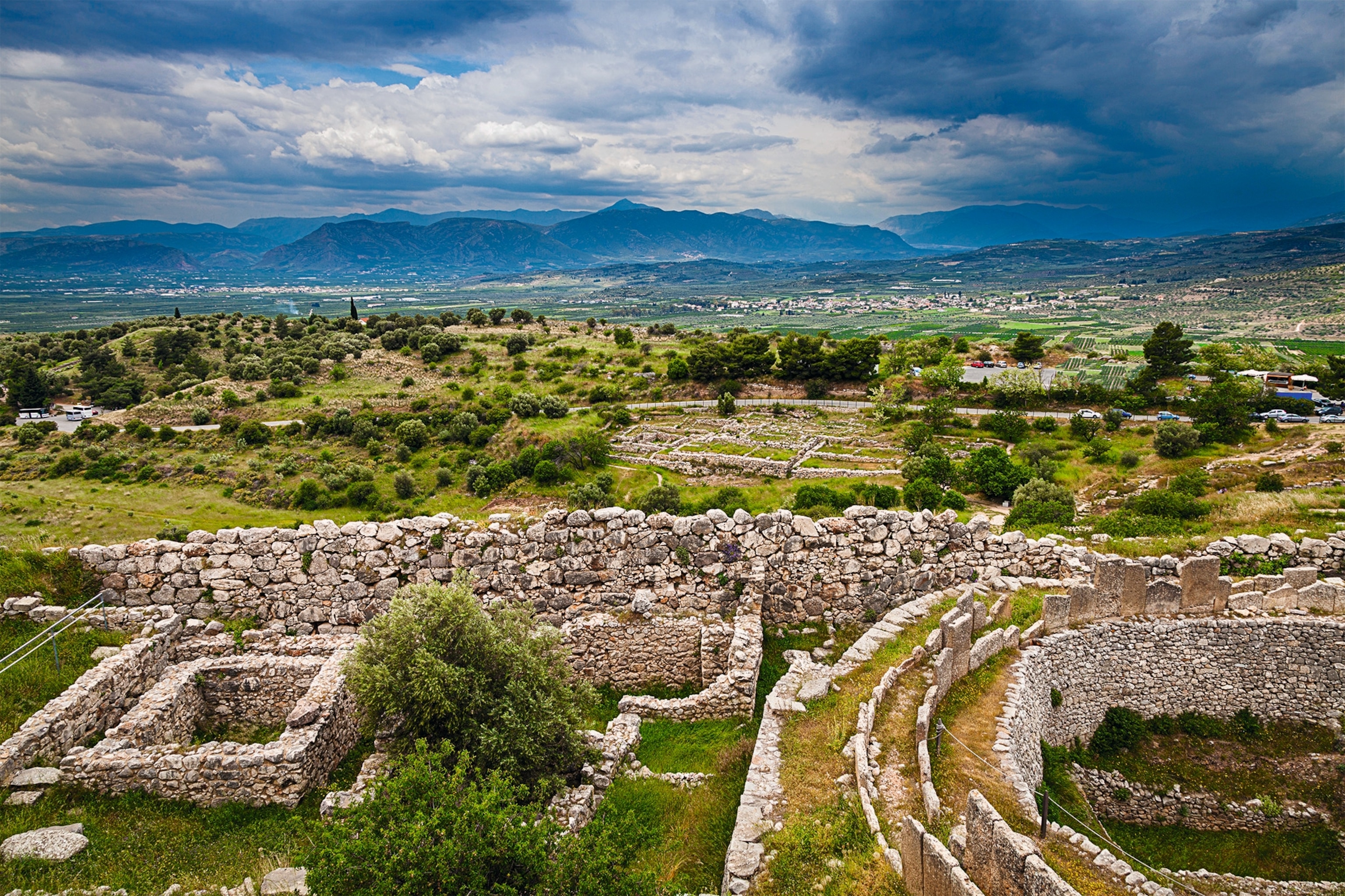 Pictured at right is part of Grave Circle A in the acropolis of Mycenae, surrounded by a wall. Shown at left are the remains of what has been identified as a granary.