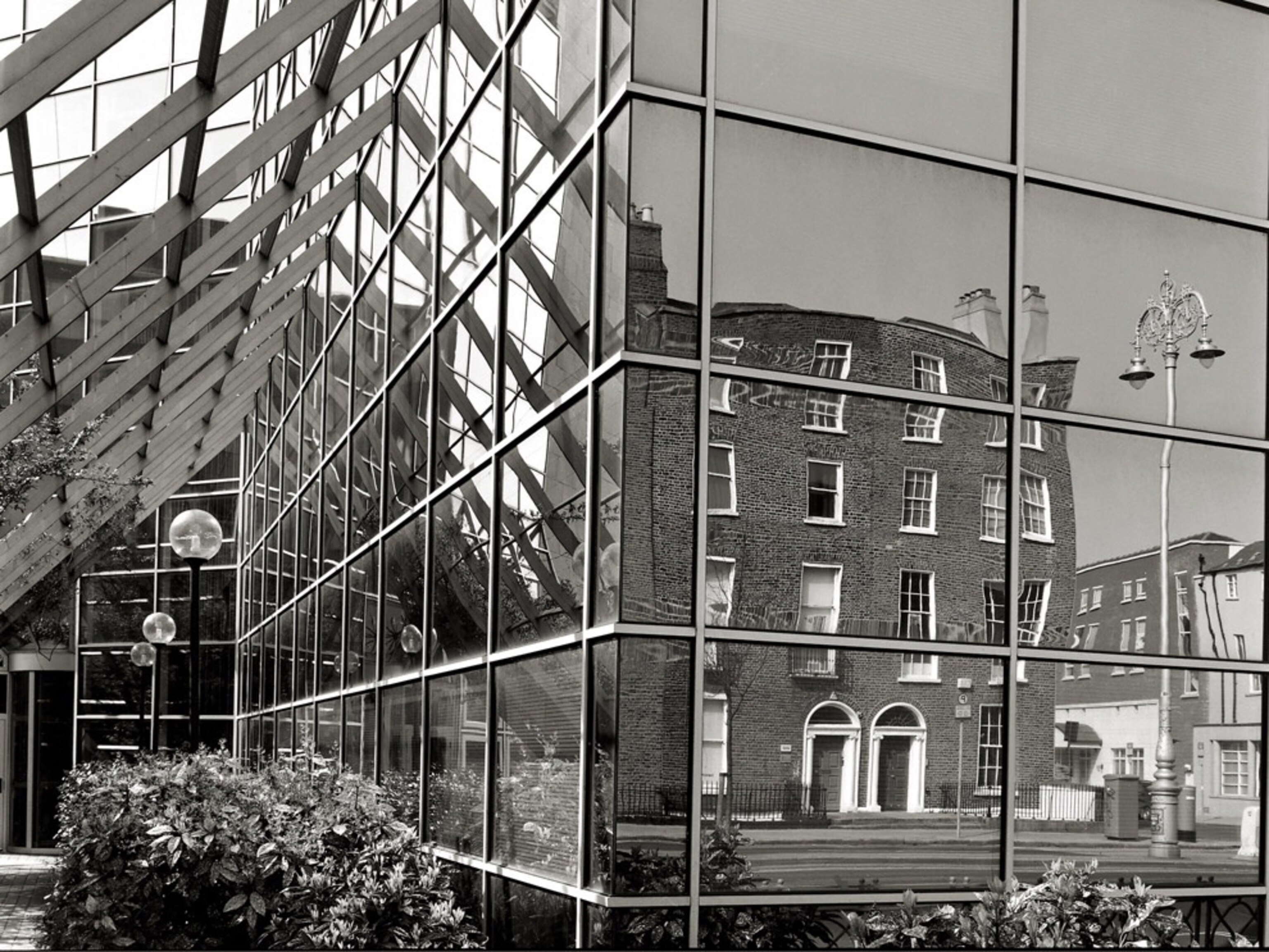 Older buildings reflected in glass windows